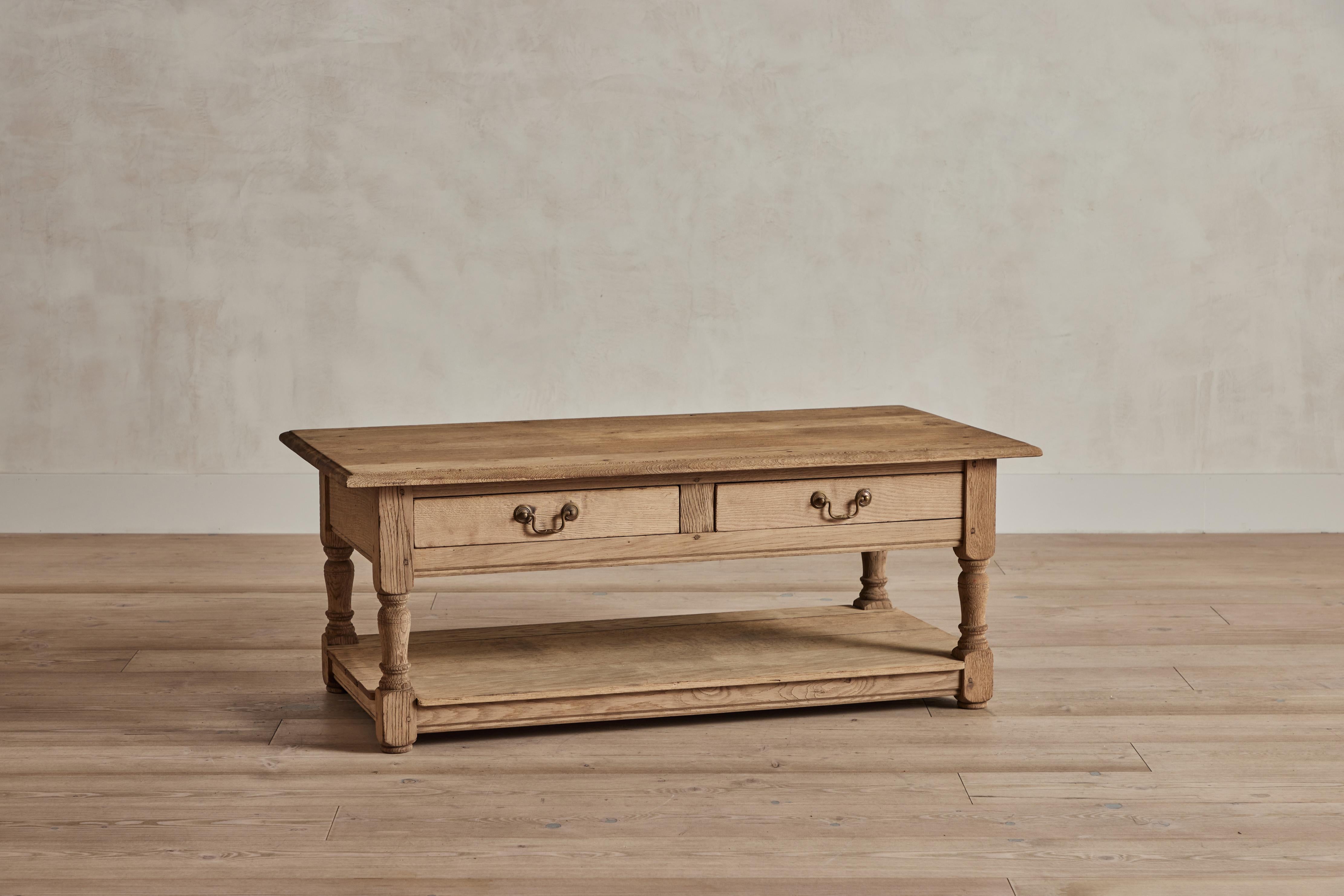 Danish 1960s two drawer coffee table with turned wood legs and lower shelf. Made of solid oak some visible wear that is consistent with age and use.  