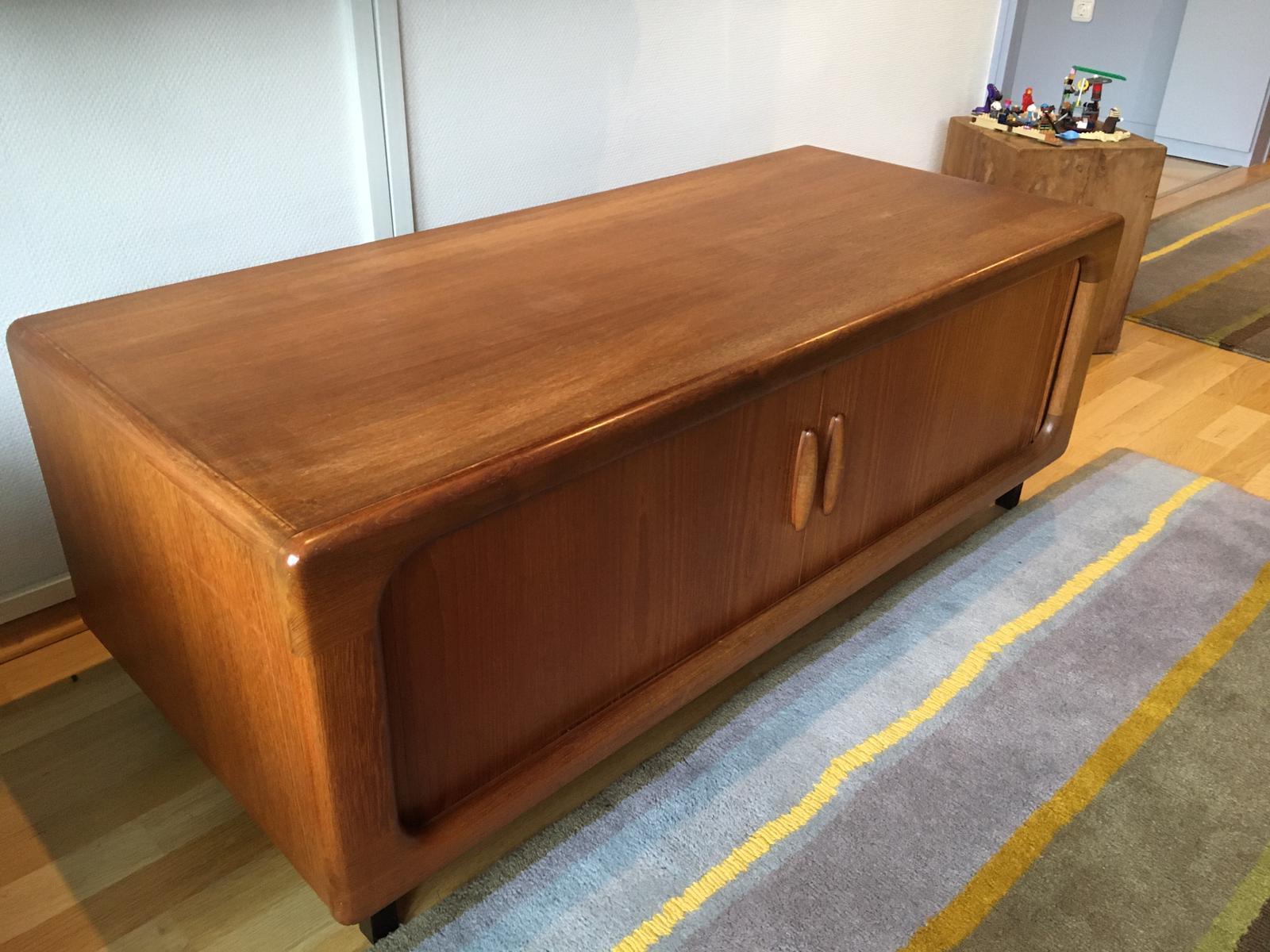 Mid century tv rack side board, with tambour doors, designed and manufactured by Dyrlund of Denmark. Produced in beautifully grained teak this piece is another classic example of Dyrlund's craftsmanship. The sheer quality of the finish is why they