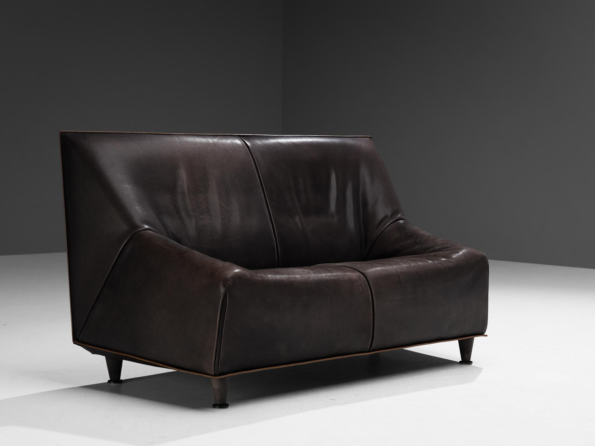 Sofa or settee, buffalo leather, metal, Denmark, 1960s. 

This sofa originates from Denmark and is characterized by a cubic shaped construction fully executed in buffalo leather with admirable patina. The seat epitomizes strong lines that gracefully