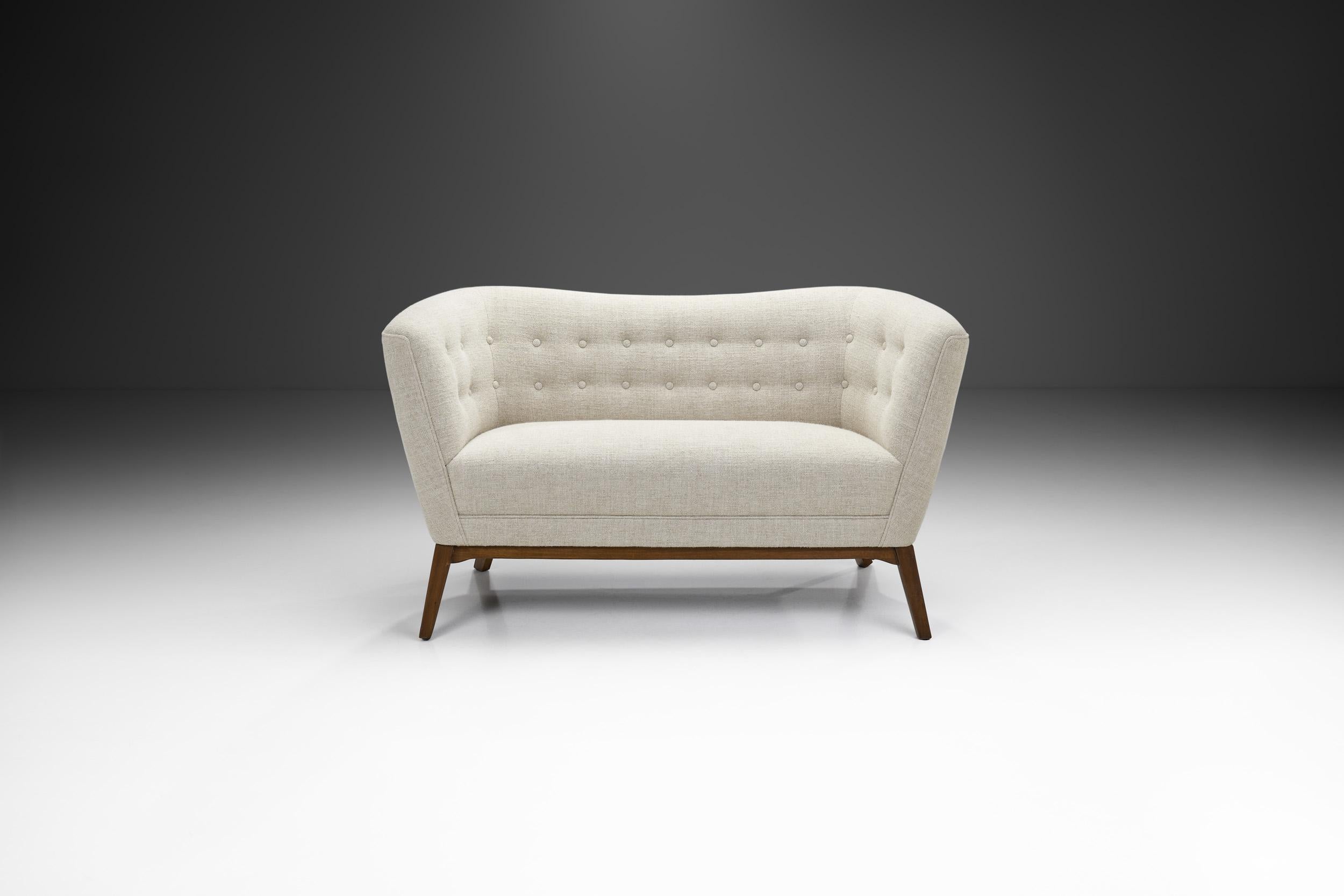 This Danish-made freestanding sofa is characterized by the best qualities of Danish mid-century design; from the restrained aesthetic to the elegant pairing of materials, this two-seater is the perfect example of how pairing Danish design, the work