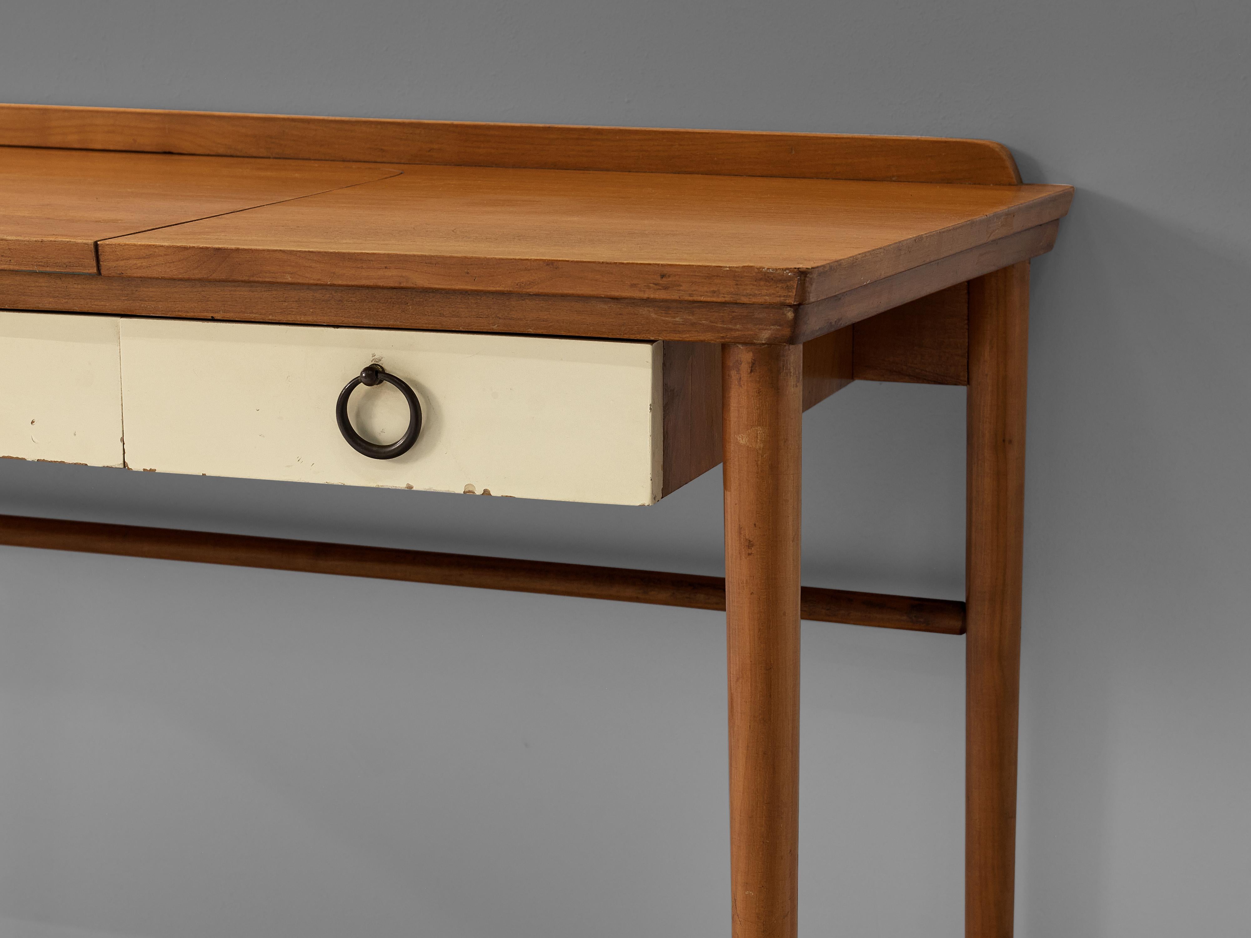 Vanity table, teak, brass, Denmark, 1950s

Nicely designed make-up console of Danish origin. The make up console table is equipped with two drawers in a lighter color in the front that have beautifully brass crafted handles. The top folds open to