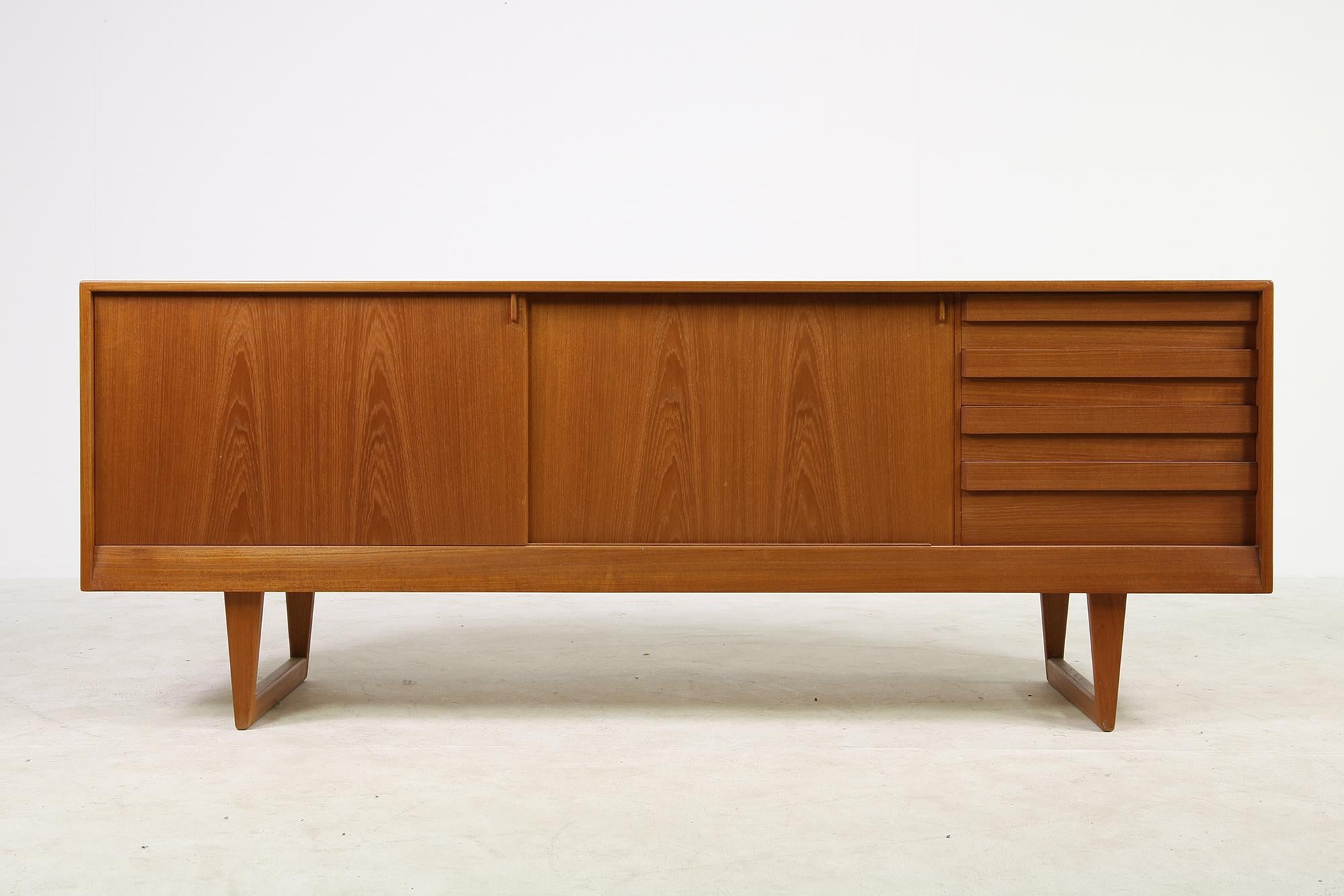 Great and large teak sideboard, from the 1960s with sliding doors and drawers, very beautiful vintage piece in a beautiful condition, looks like a display item from 1960 it was in a guest room in an architect house from 1965 on and was as good as