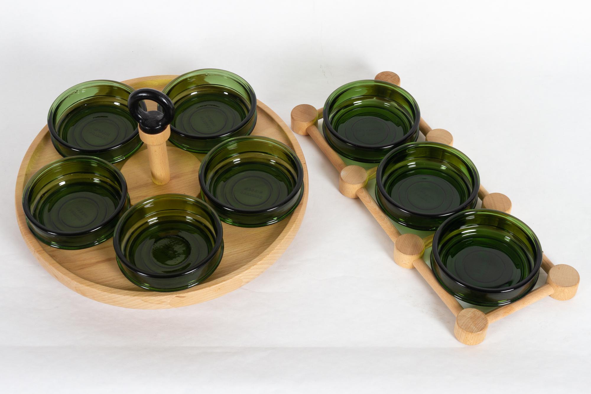 Danish vintage cabaret serving trays 1970s
Two serving trays with green glass bowls from Danish manufacturer Nissen. One tray is rotatable with five bowls. Both are made in solid beech, the large tray has top in cast iron.
The bowl measures 11.5