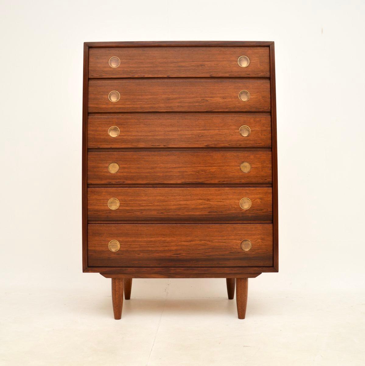 A stylish and extremely well made Danish vintage chest of drawers. This was made by Dyrlund, it dates from around the 1960’s.

The quality is outstanding, this sits on tapered legs and has lovely brass circular handles. The grain patterns and colour