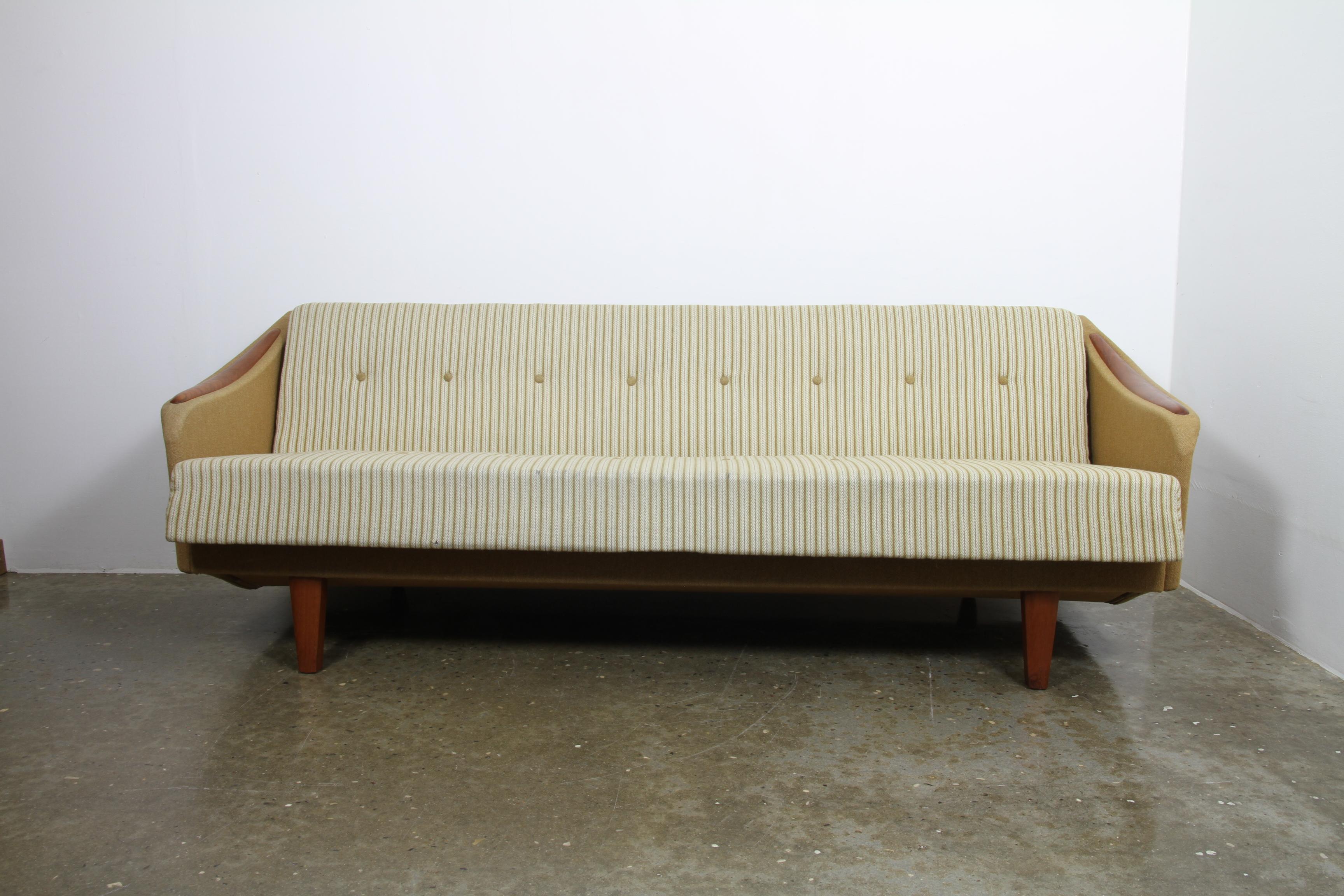 Mid-Century Modern sofa with teak nails and legs. Folds out to a bed 186 x 94 cms. Intact original upholstery. Very retro looking and comfortable. Great vintage condition.