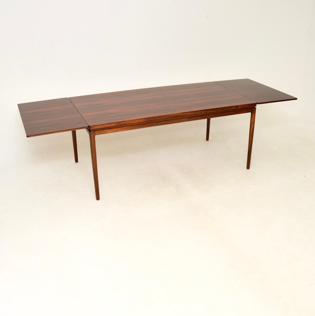 An absolutely stunning Danish vintage dining table by Johannes Andersen.

It is of superb quality and is a great size. It extends to comfortably seat ten people, and could seat twelve at a push. The leaves are completely flat and must be stored