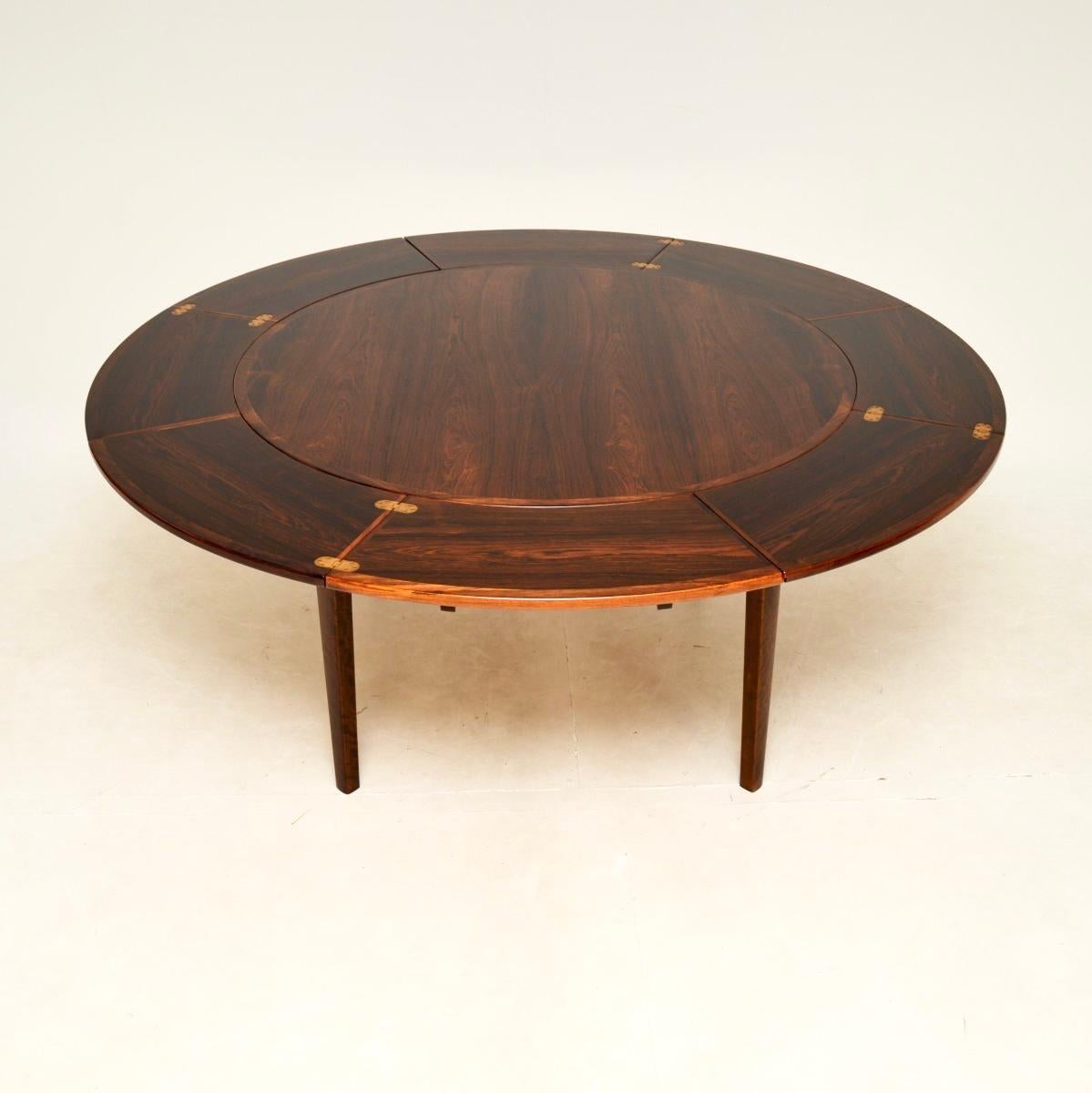 An absolutely stunning and iconic Danish vintage Flip Flap Lotus dining table by Dyrlund. This was made in Denmark, it dates from the 1960’s.

This is a superb quality table with a fantastic design. When closed the circular top can seat four, there