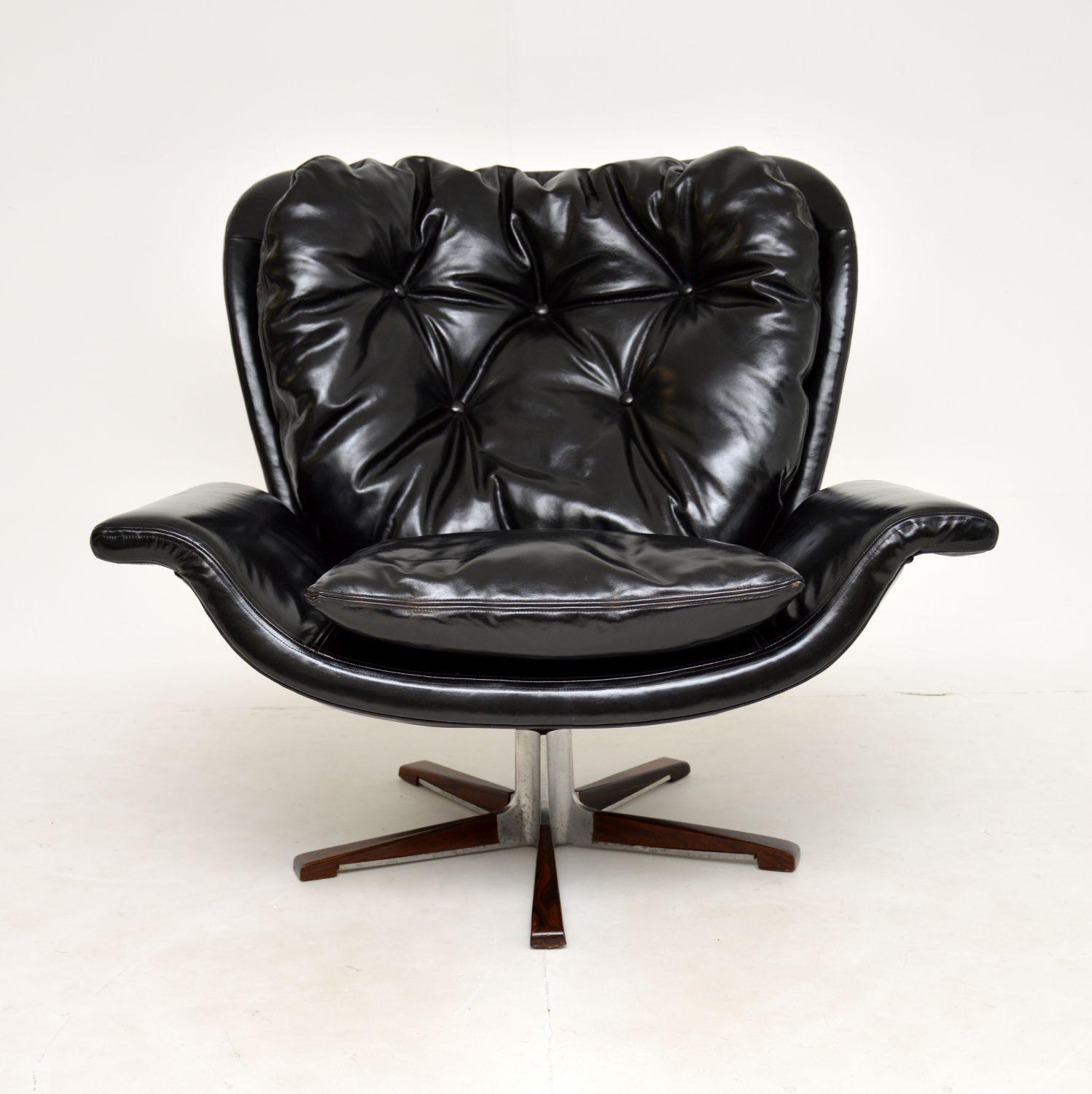 A magnificent vintage leather swivel armchair on a wood and steel base. We believe this was made in Denmark, it dates from around the 1960-1970’s.

The quality and design are incredible, this is up there with the best vintage armchairs you could