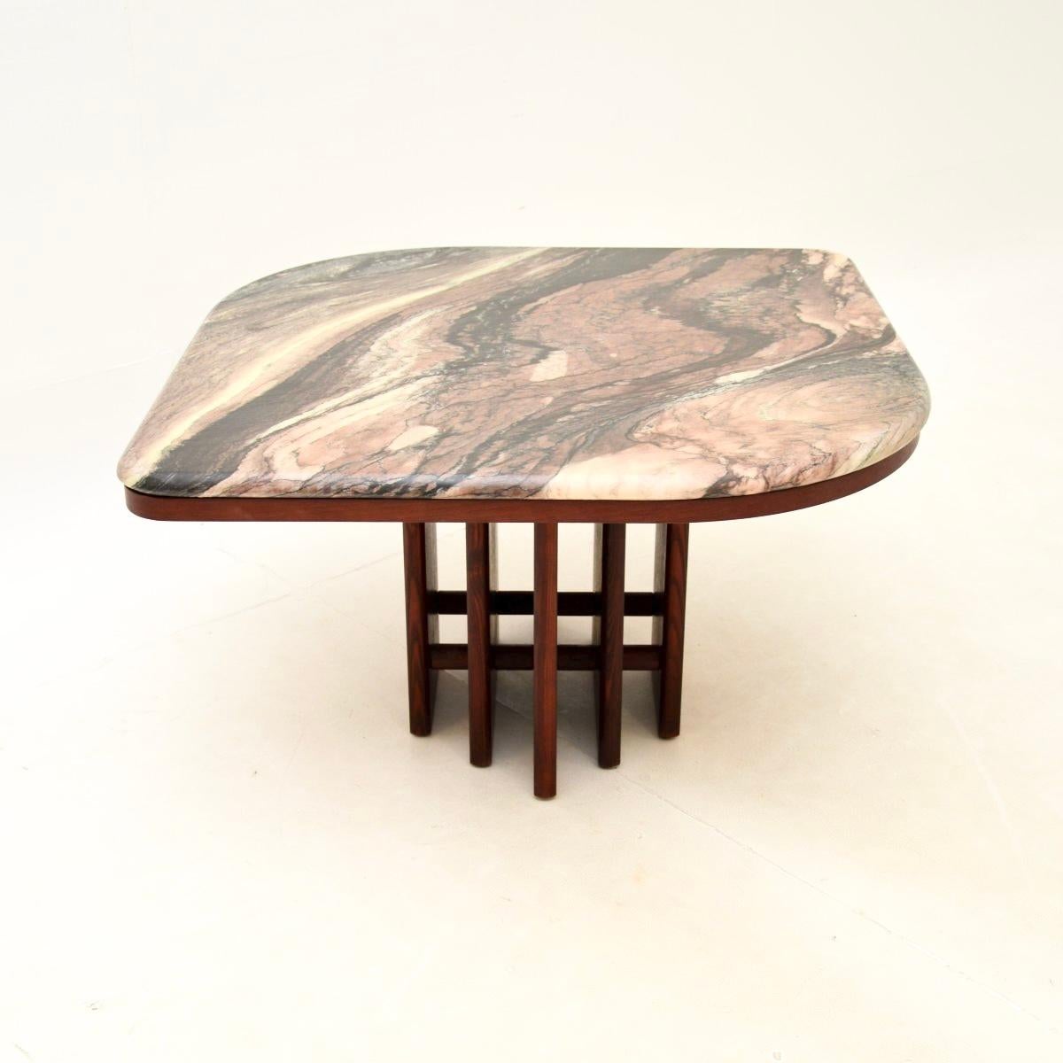 A stylish and very impressive Danish vintage marble top coffee table, dating from the 1970’s.

The quality is outstanding, this has an absolutely stunning marble top with gorgeous colours. The base is stained teak, with a very interesting design to