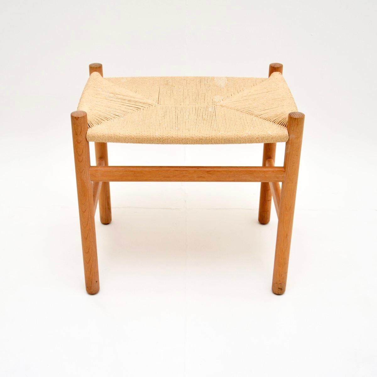 A stylish and extremely well made Danish vintage oak CH53 stool by Hans Wegner for Carl Hansen. The CH53 stool was originally designed in the 1950’s, this one dates from 2008 and has the Carl Hansen label beneath the frame.

It is solid oak, the