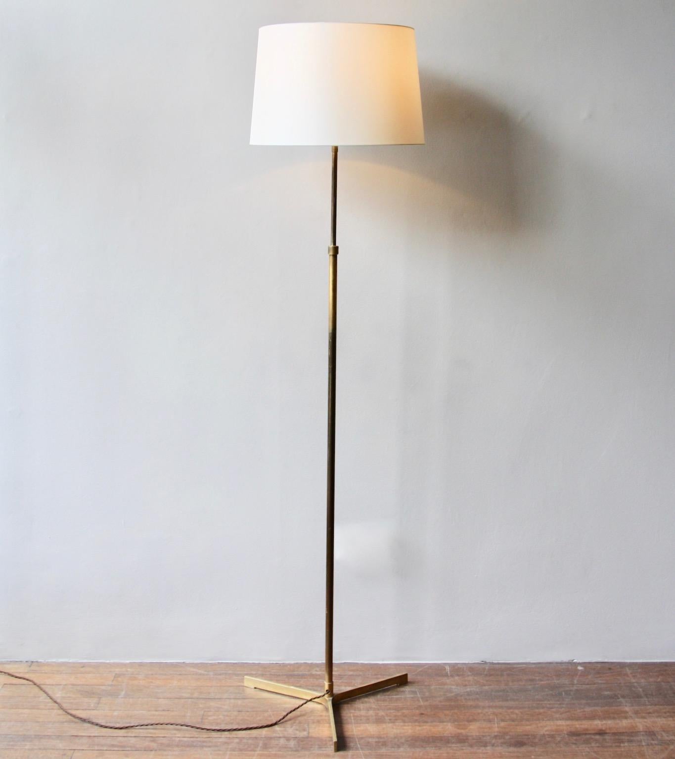 A vintage floor lamp made purely of brass in Denmark, circa 1960.
The light is made up of three simple sections; a'crows foot' base a thick central shaft and, lastly, a more slender pole. Connecting the aforementioned sections are two collars which