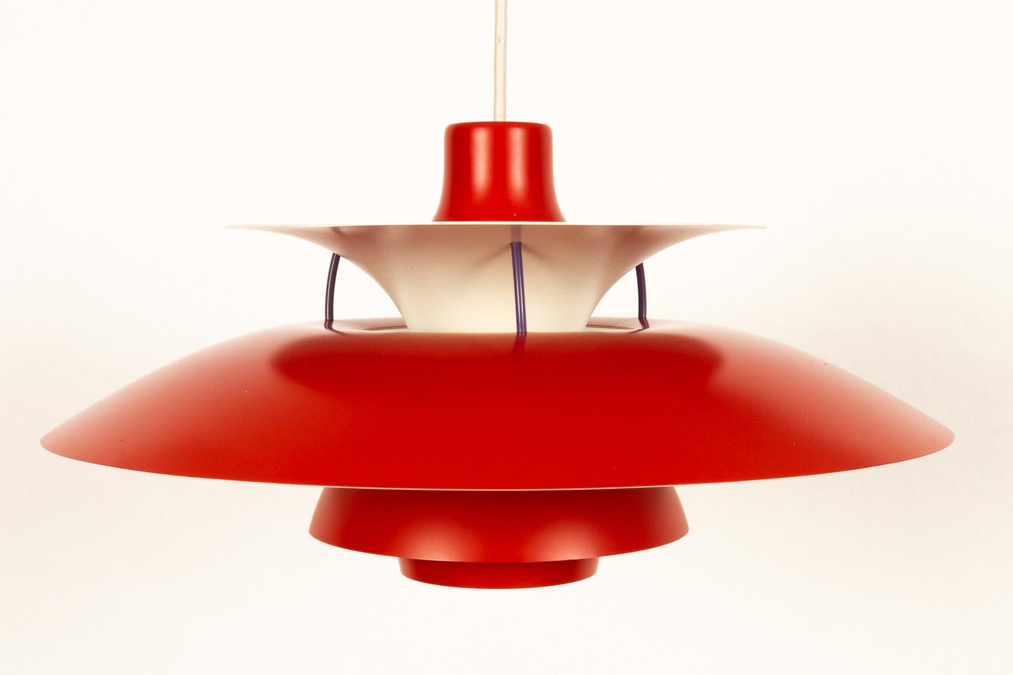 Danish vintage red ceiling pendant PH5 by Poul Henningsen 1970s.
Iconic Danish lighting designed in 1958 by Poul Henningsen for Louis Poulsen. This model is known as PH 5 because it has five individual shades. Upper sides in a beautiful warm red