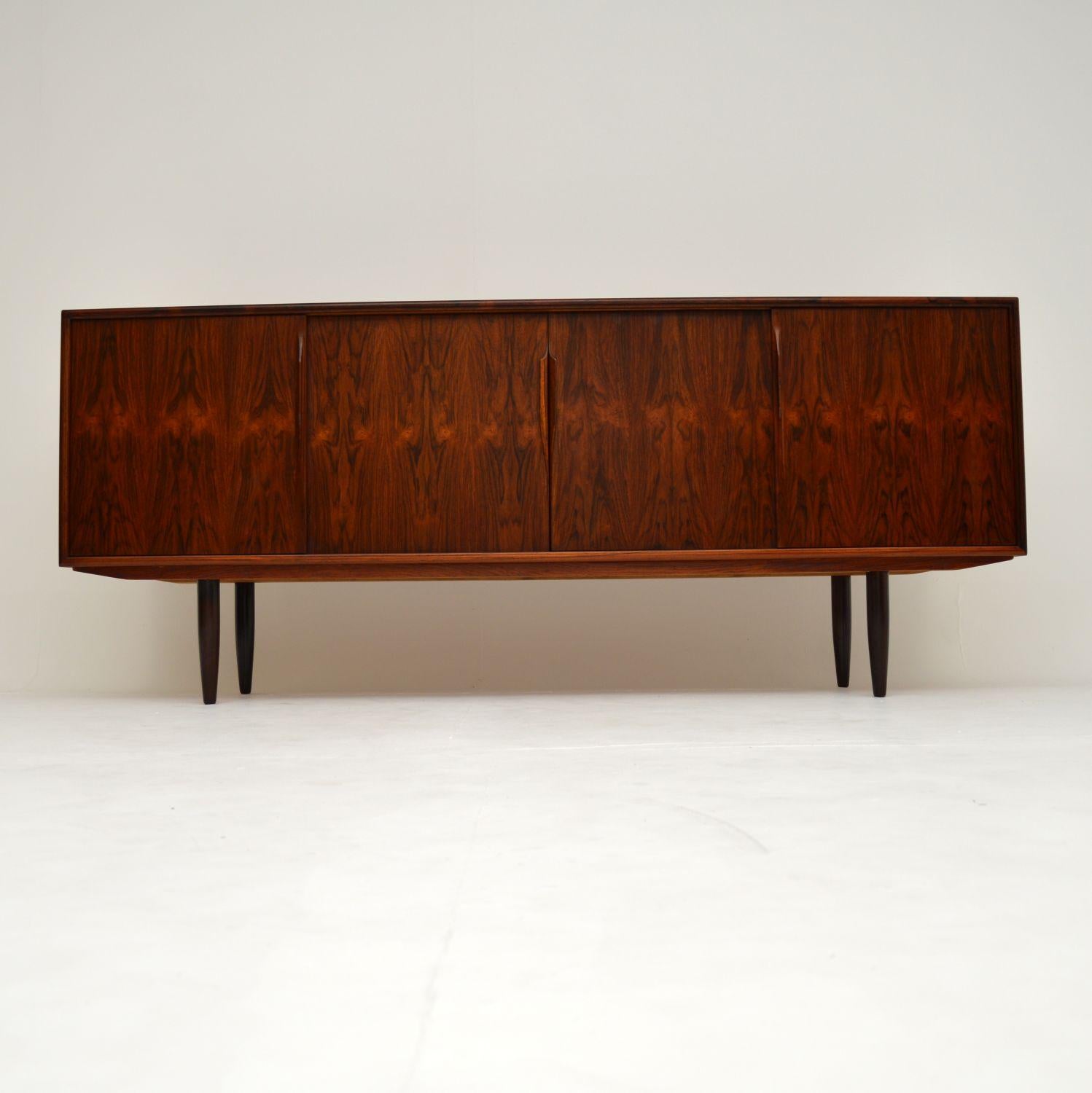 A stylish and extremely well made vintage Danish sideboard, this was designed by Gunni Omann for Axel Christensen. It was made in Denmark during the 1960’s, and is in superb condition for its age.

We have just had this re-polished, the colour and