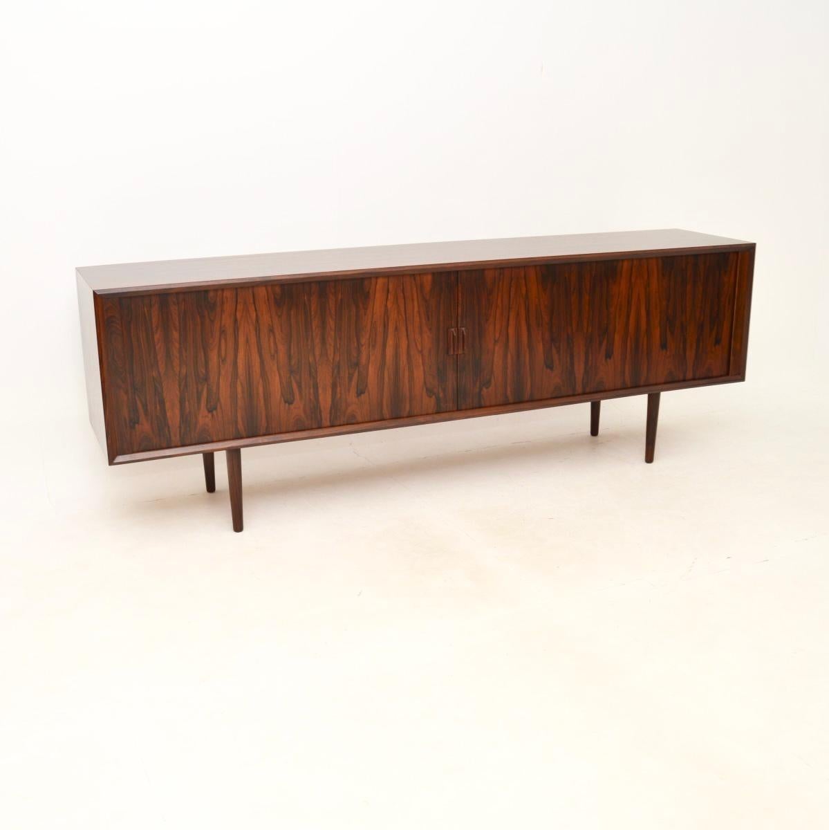 A stunning and extremely well made Danish vintage sideboard by IB Kofod Larsen. It was made in Denmark by Faarup, it dates from the 1960’s.

This is of outstanding quality and has a very stylish design. The tambour doors are beautifully made, they