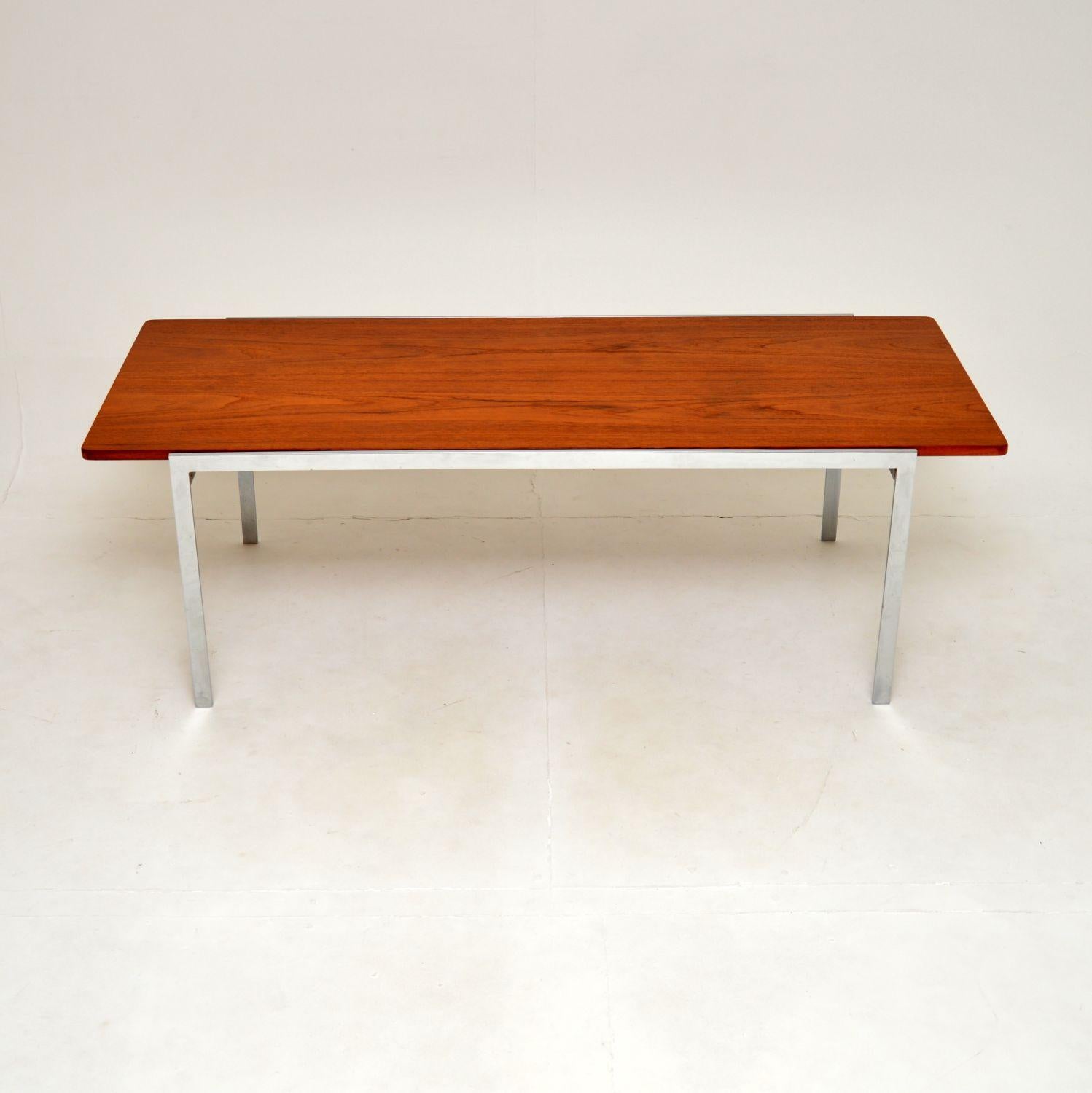 A stylish and very rare Danish vintage teak and chrome coffee table by Arne Jacobsen. This was made by Fritz Hansen, it dates from the 1960’s.

It is of superb quality, it is a large and impressive size. The teak top has stunning grain patterns and