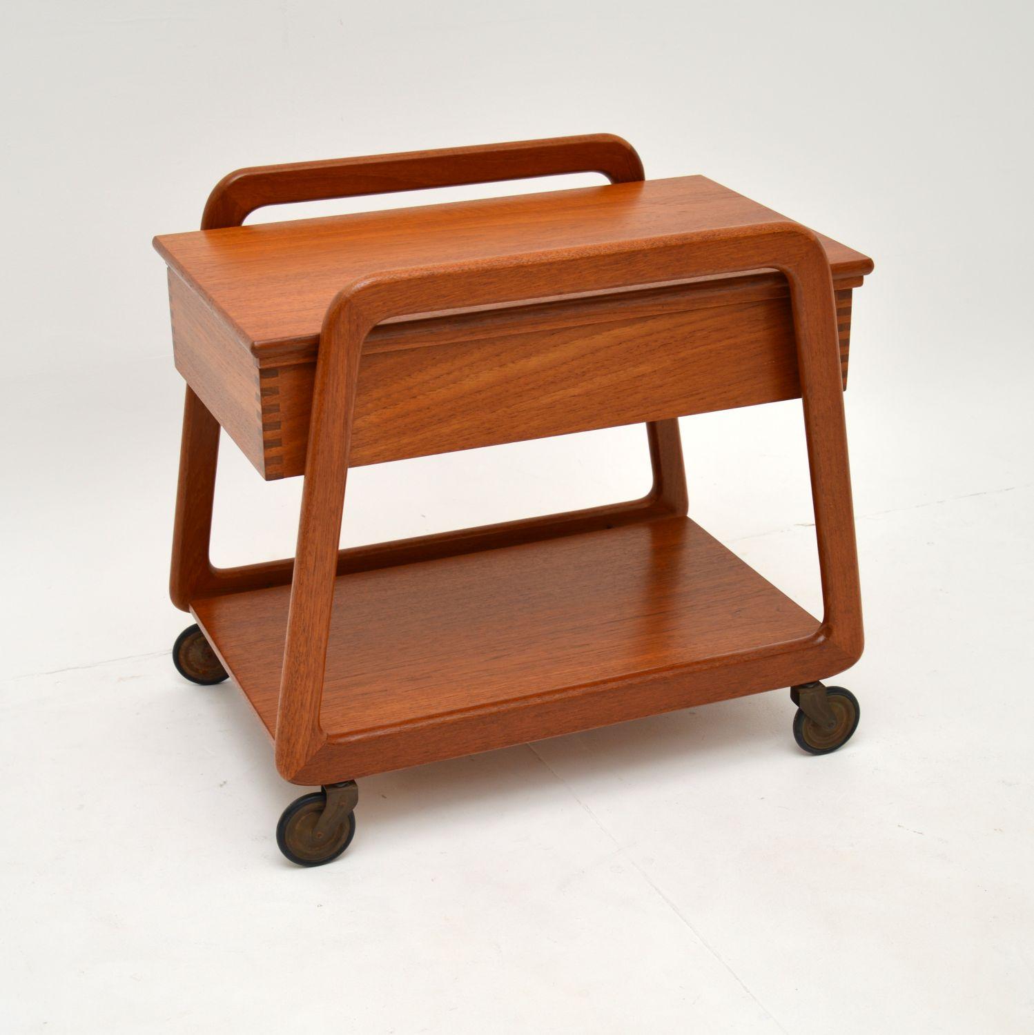 A stylish and useful Danish trolley table on casters. This was made in Denmark by Sika mobler, it dates from the 1960’s.

The quality is outstanding and this is a very practical item. It was originally designed as a sewing side table, with various