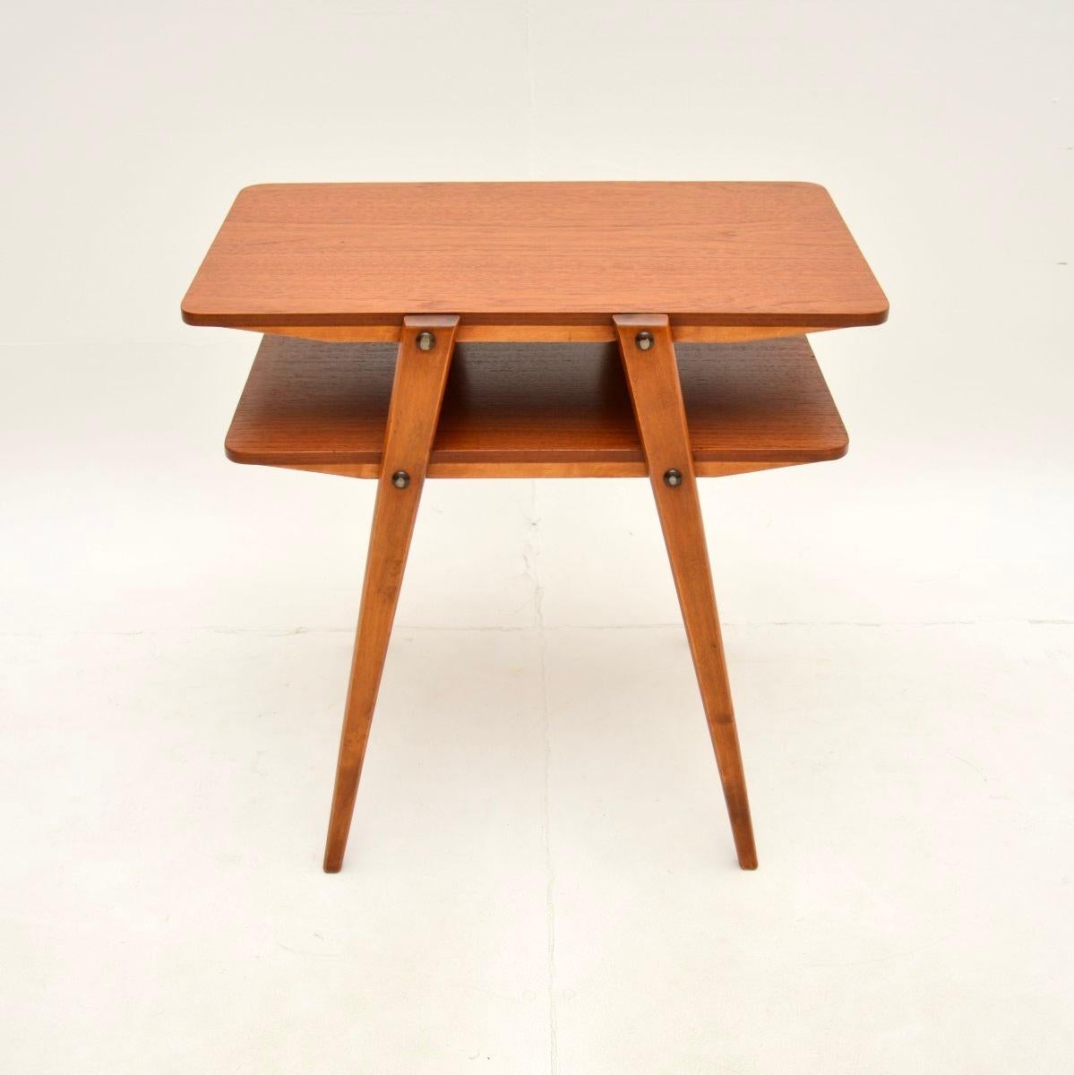 A stylish and very well made Danish vintage teak two tier side table, dating from the 1960’s.

This is of lovely quality, it is beautifully designed and is a very useful size. The top and lower tiers are made from gorgeous teak, the stylish angular
