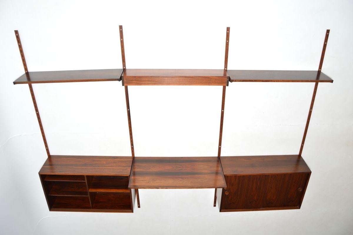 A superb Danish vintage wall mounting shelving system. This was made in Denmark by FM Mobler, it dates from the 1960’s.

This ingenious shelving system is very stylish, versatile and of amazing quality. It consists of three vertical wall mounting