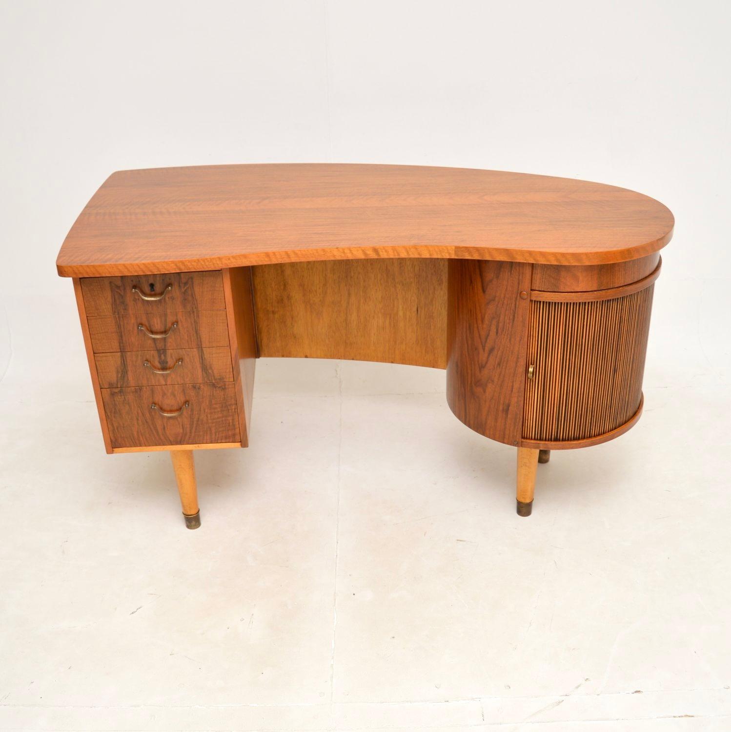 An absolutely spectacular Danish vintage walnut desk by Kai Kristiansen. This is the model 54 desk, it was made in Denmark in the 1950’s.

It is of amazing quality and has an incredible design. The top has an asymmetrical shape, on one side of the