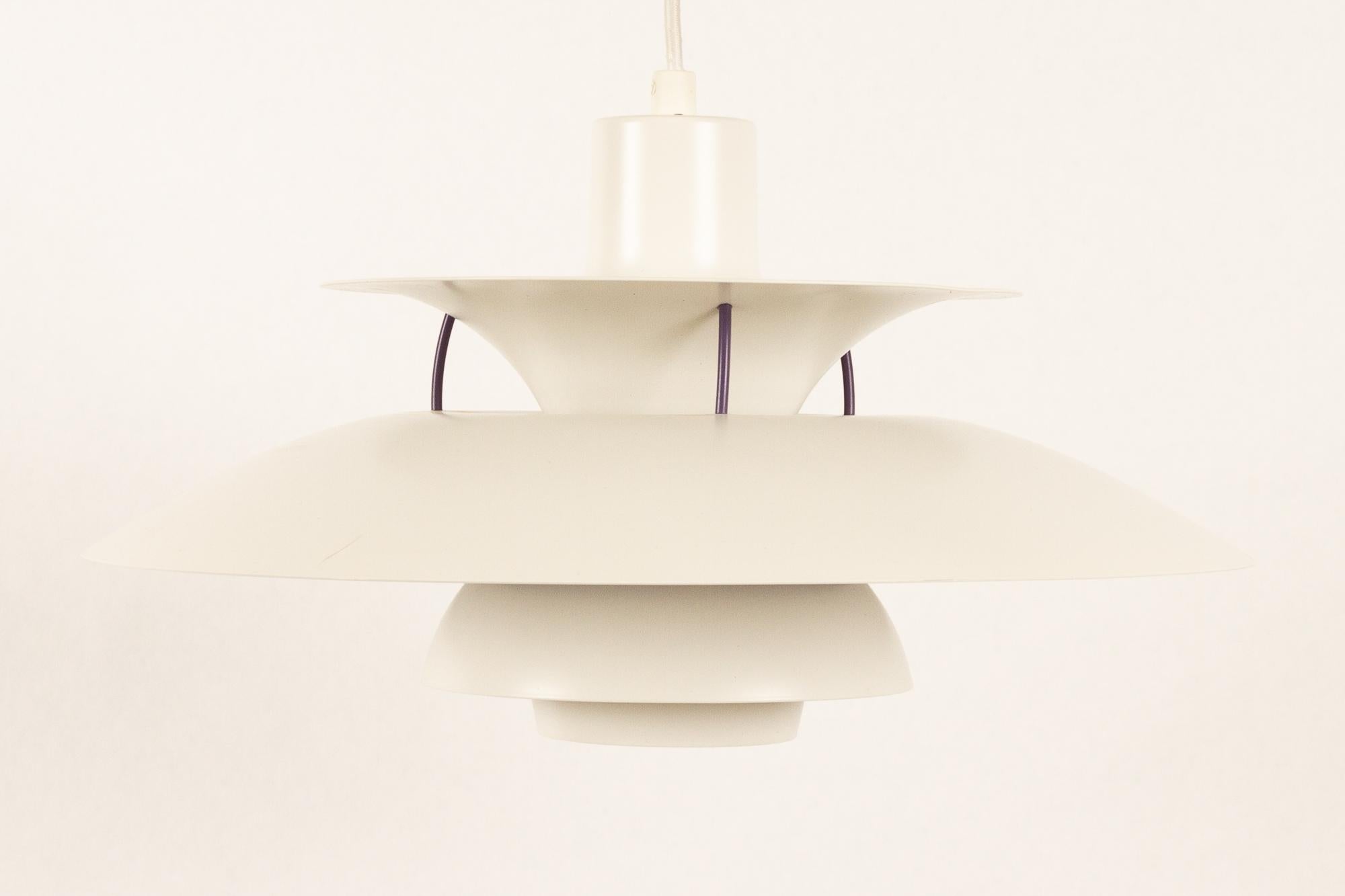 Danish vintage white ceiling pendant PH5 by Poul Henningsen 1990s.
Iconic Danish lighting designed in 1958 by Poul Henningsen for Louis Poulsen. This model is known as PH 5 because it has five individual shades. Emits a soft light outwards and