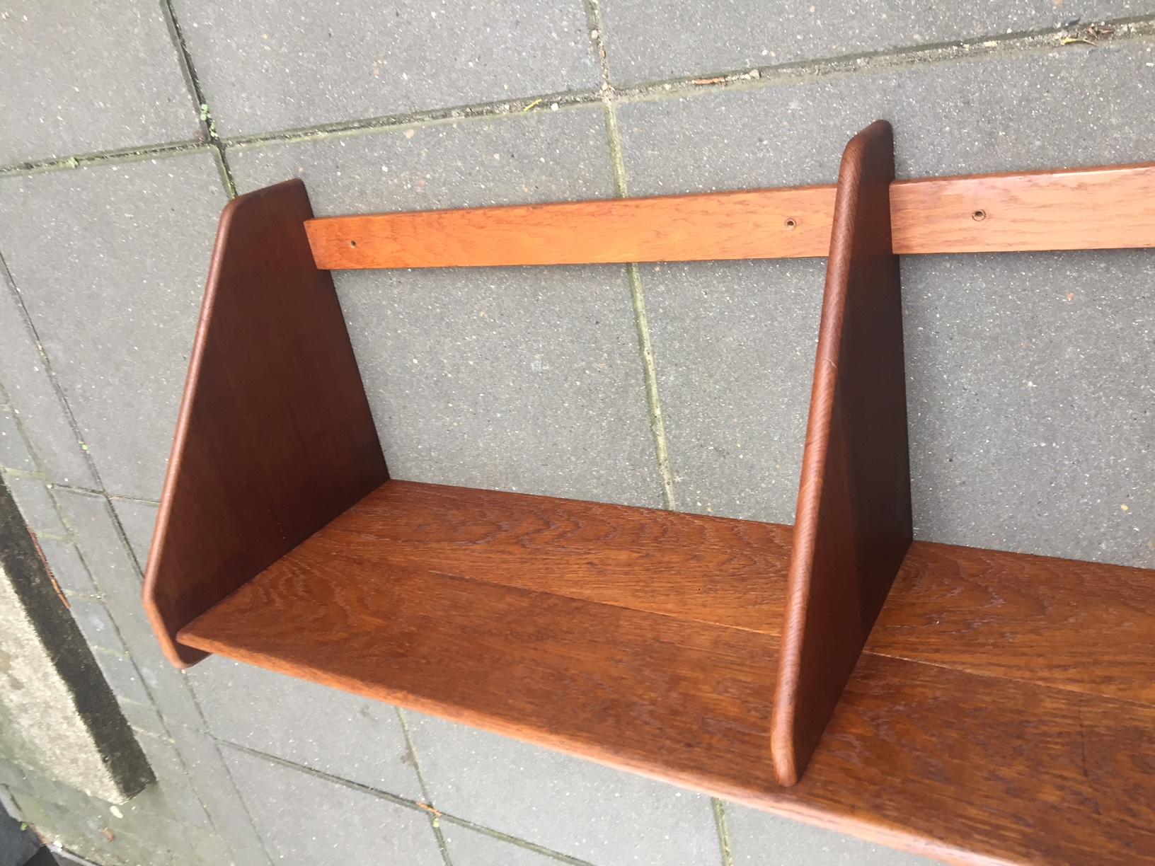 Oak and teak shelf designed by Hans Jorgen Wegner and manufactured by Ry Møbler i Denmark during the 1950s. This composition in oak and teak is rather rare especially in the large version (W: 100 cm).