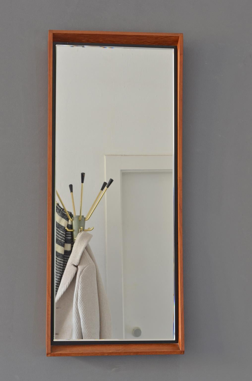 Danish wall mirror with crystal cut edge, brown teak frame, 1960s.
 