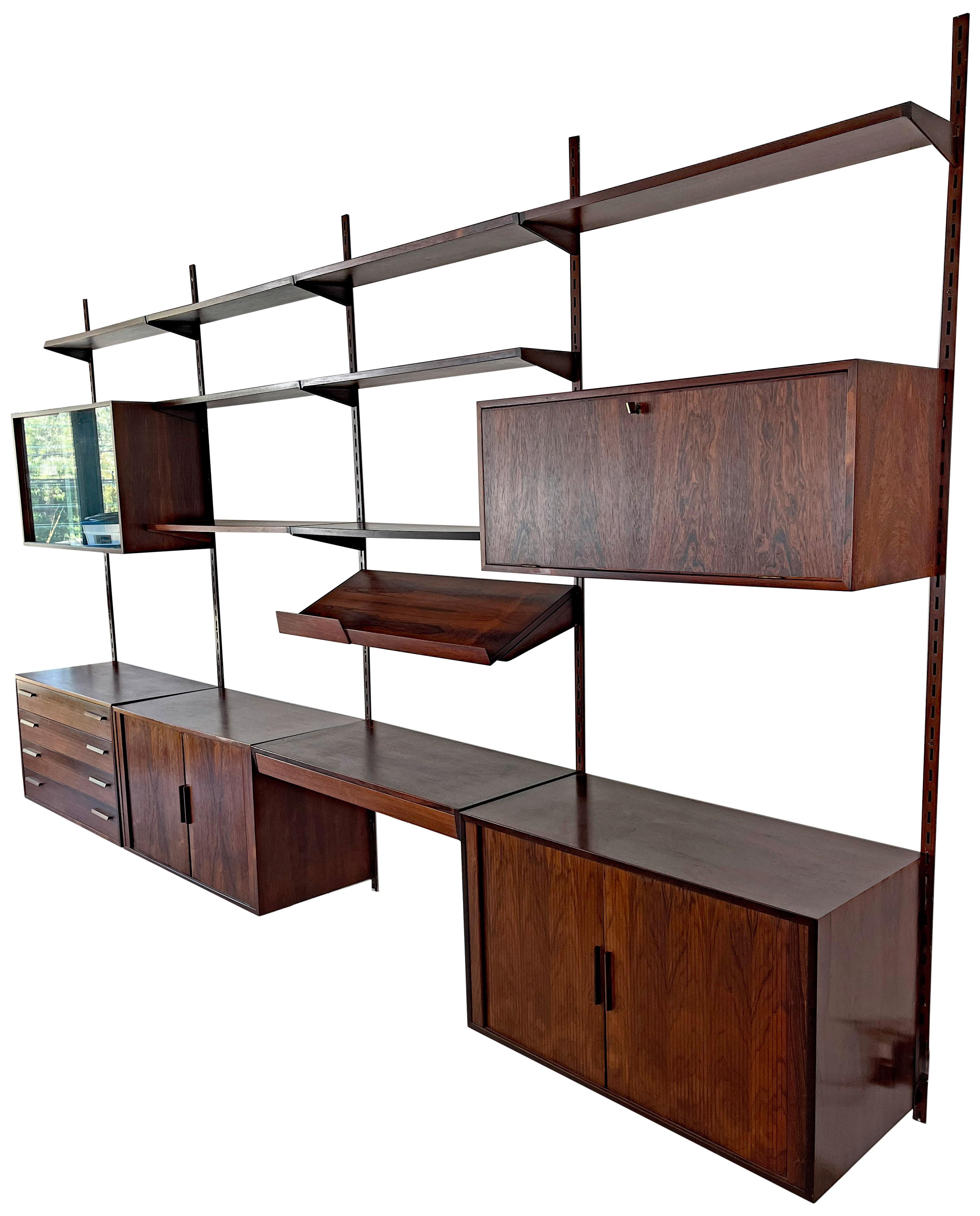 Very elegant 1960s rosewood 4 bay wall unit by Kai Kristiansen for FM Møbler, Denmark. This Scandinavian modern design allows one to arrange the cabinets, shelves, and workspace to fit your home or business storage and display needs. 



1 x display