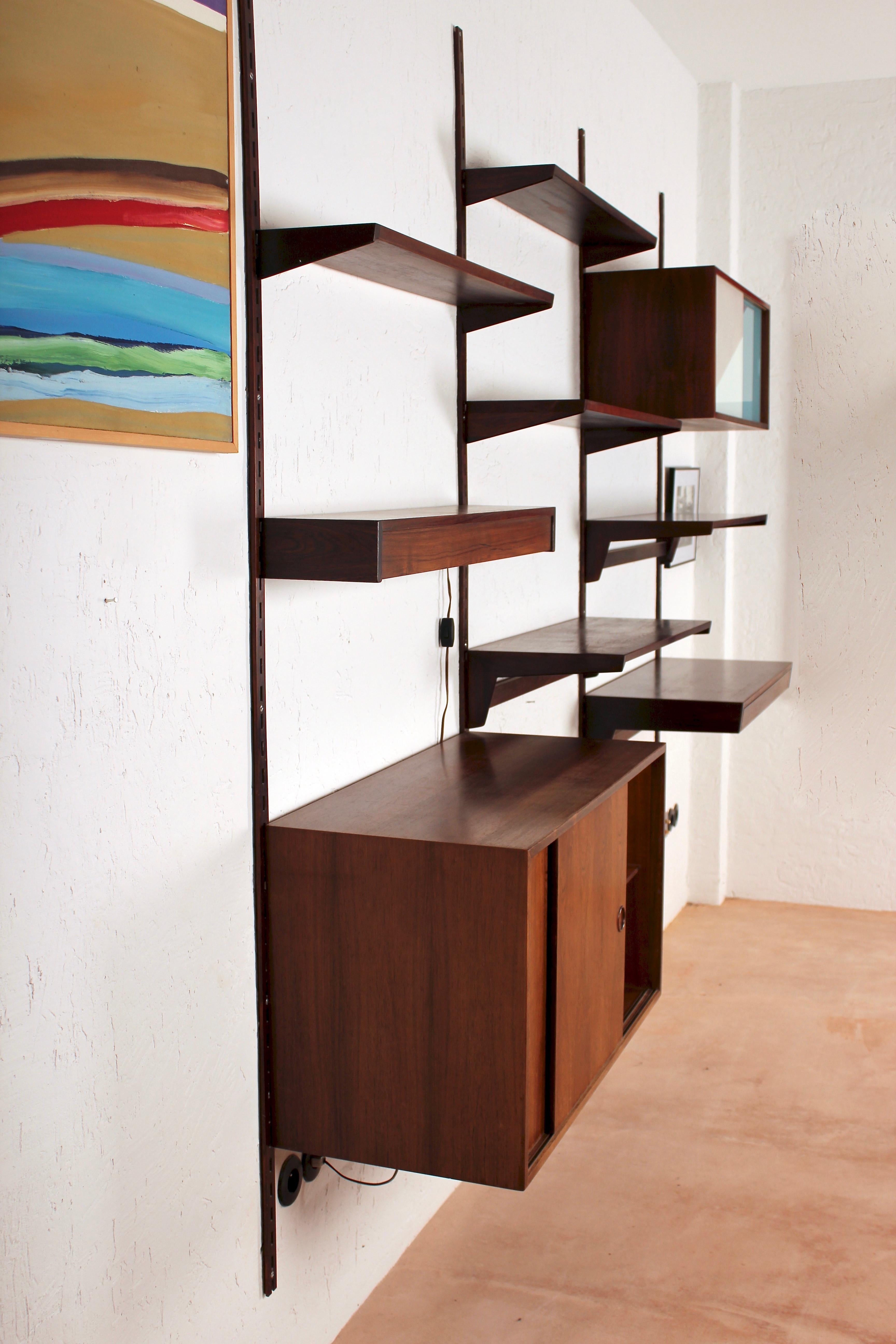 Very elegant 1960s rosewood 10 pieces wall unit by Kai Kristiansen for FM Møbler, Denmark. 1 box with sliding doors in lamellae, 1 box with sliding glass, 1 electrified shelf, 1 shelf with drawer and 6 shelves.
