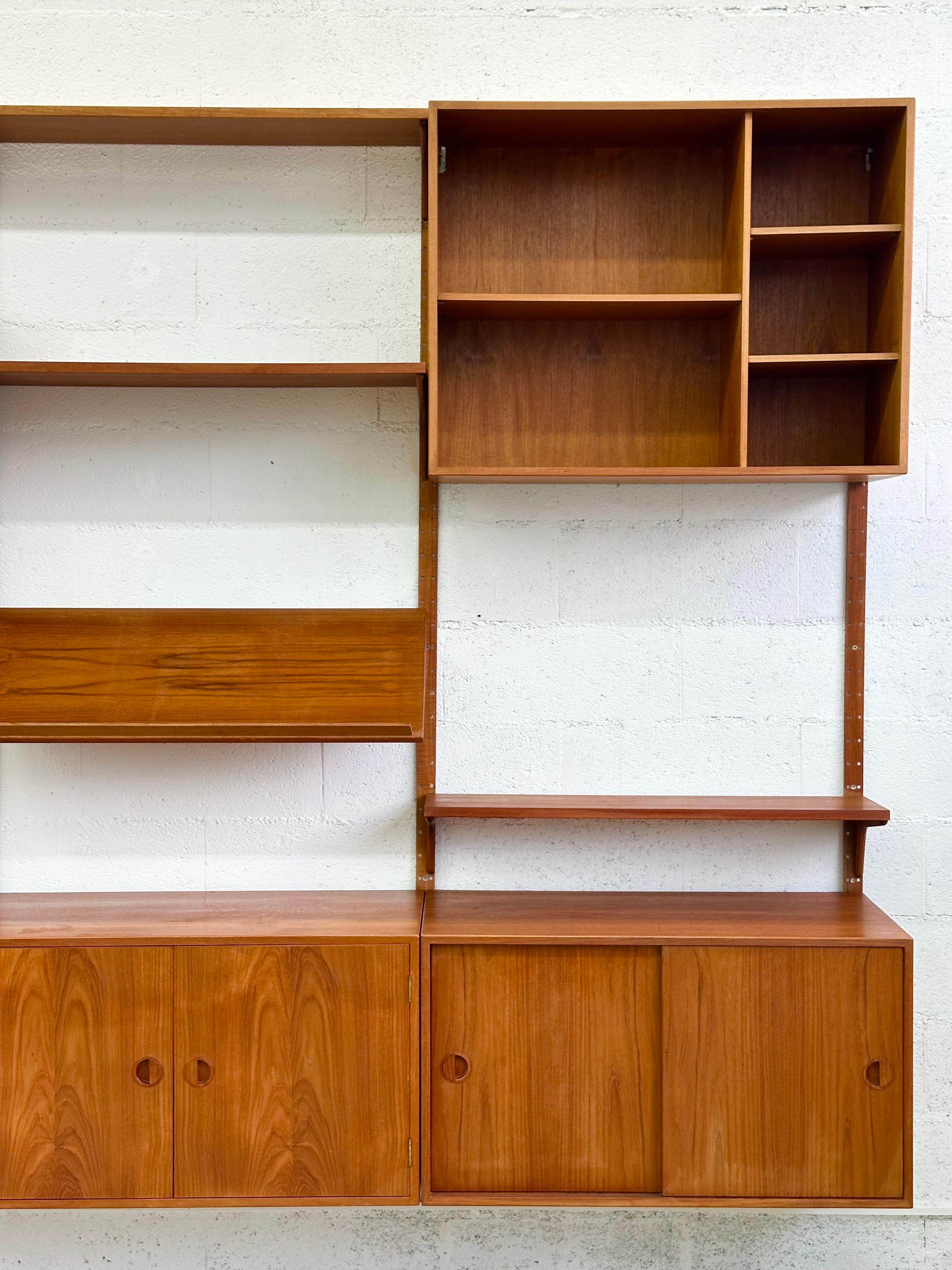A remarkable and functional Danish Mid Century Modern wall unit, designed by Rud Thygesen and Johnny Sorensen for HG Furniture Denmark, 1960s.
Highly decorative unit, completely modular, with sculpted handles, all cabinets and shelves can be