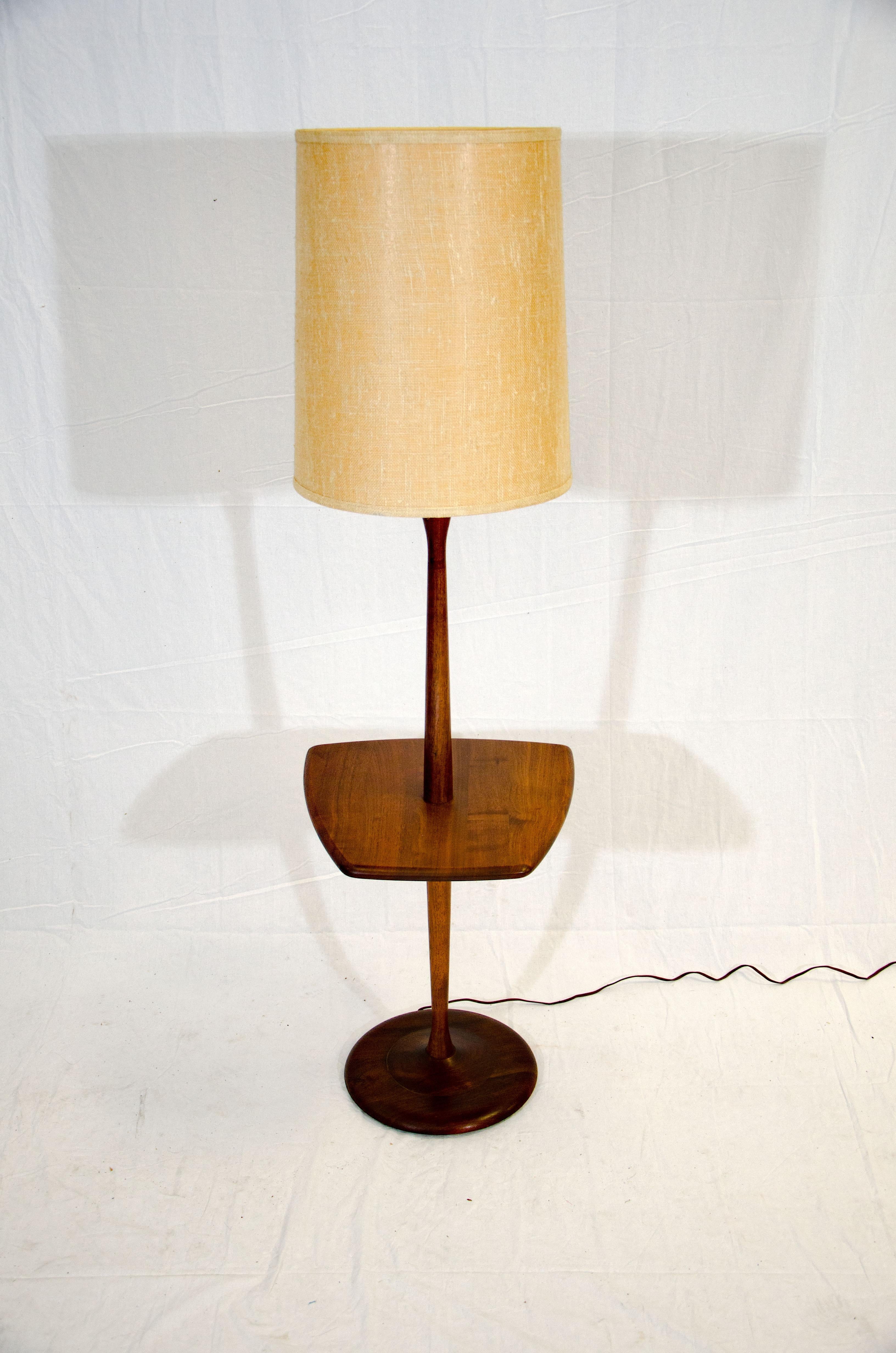 Useful Danish walnut floor lamp with a small attached beverage or magazine table that you can place next to your favorite reading chair. The small table measures 21 3/4