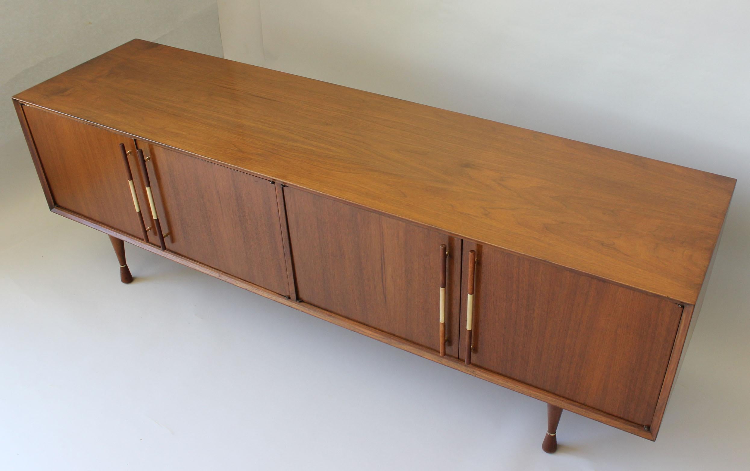 A midcentury Danish style American walnut sideboard with brass details.