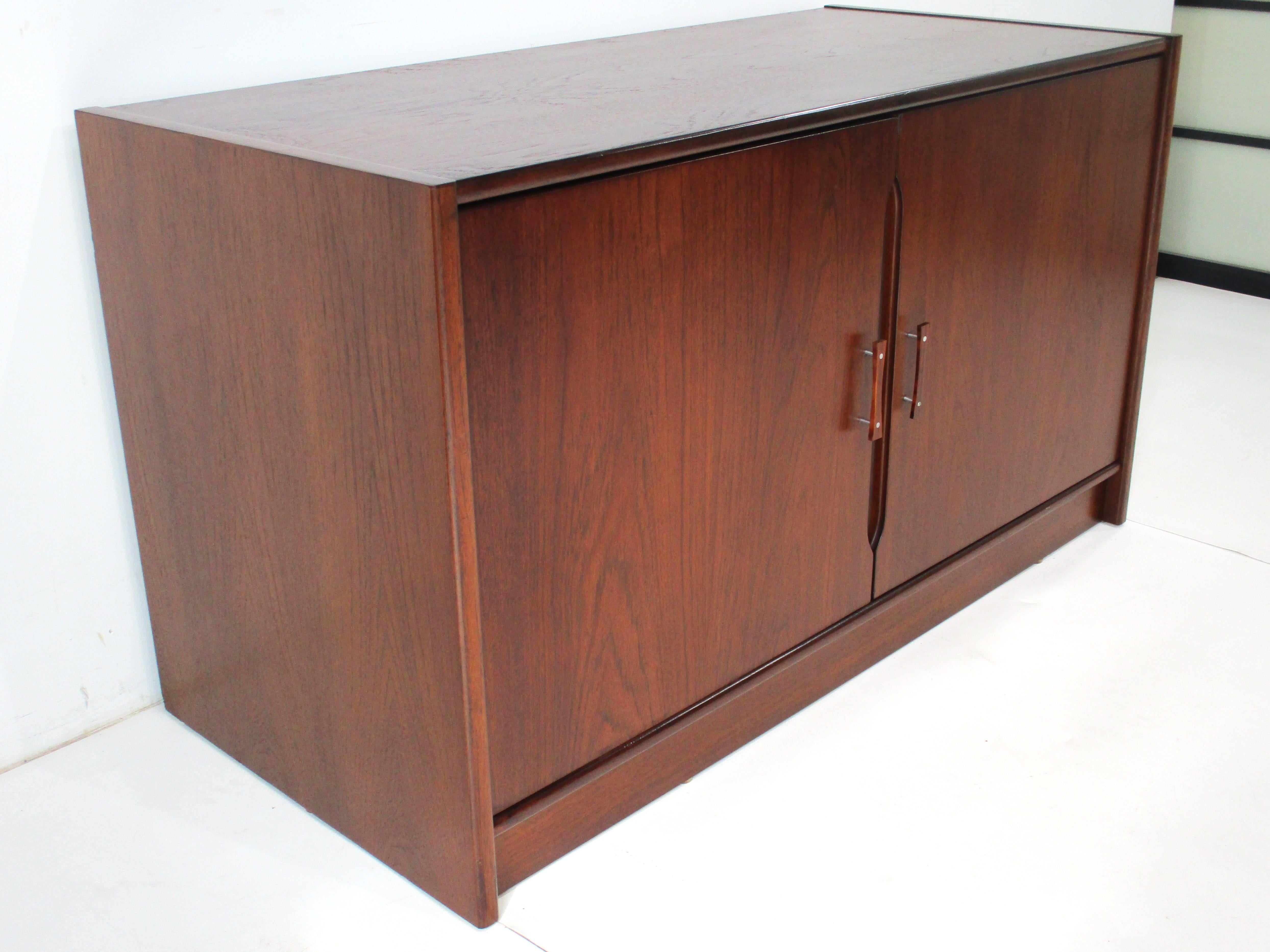 A dark walnut two door stereo / record cabinet with two adjustable shelves and two pullout sliding shelves for your tuner and turntable . Holes cut to the backside for cords and well crafted so that it's very sturdy for heavy records and equipment ,