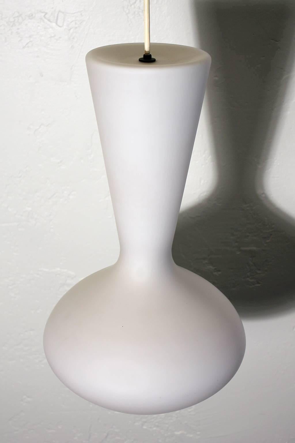 Modernist opal frosted glass hanging pendant lamp by Holmegaard, circa 1960s. This Danish lamp has great design and form. Can be added to so many rooms for an elegant modernist look. In excellent shape and works great.