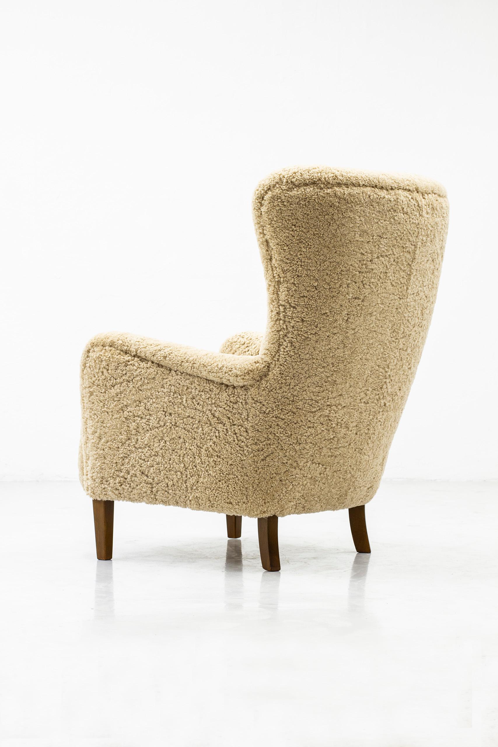 Scandinavian Modern Danish Wing Back Chair with Sheep Skin in the Manner of Frits Henningsen