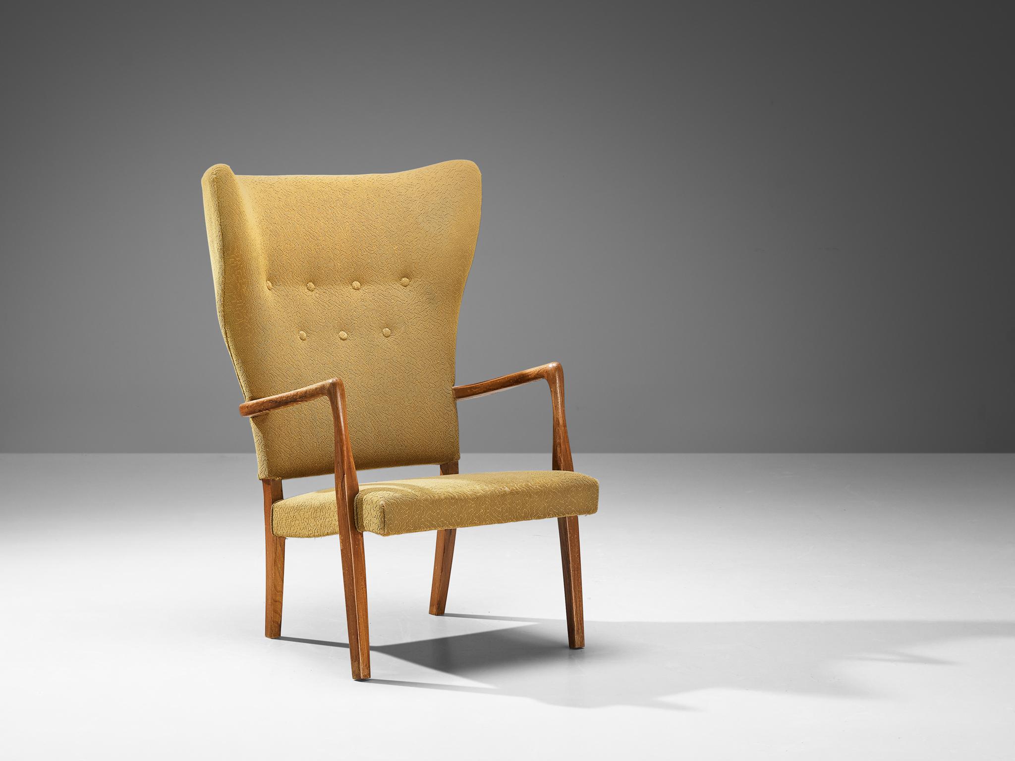 Armchair, yellow fabric and teak, Denmark, 1950s

This stately and extremely well-executed wingback chair shows an exquisite level of craftsmanship. The lines and finishes in this chair from 1950 are curvy yet crisp. The teak frame shows traits of