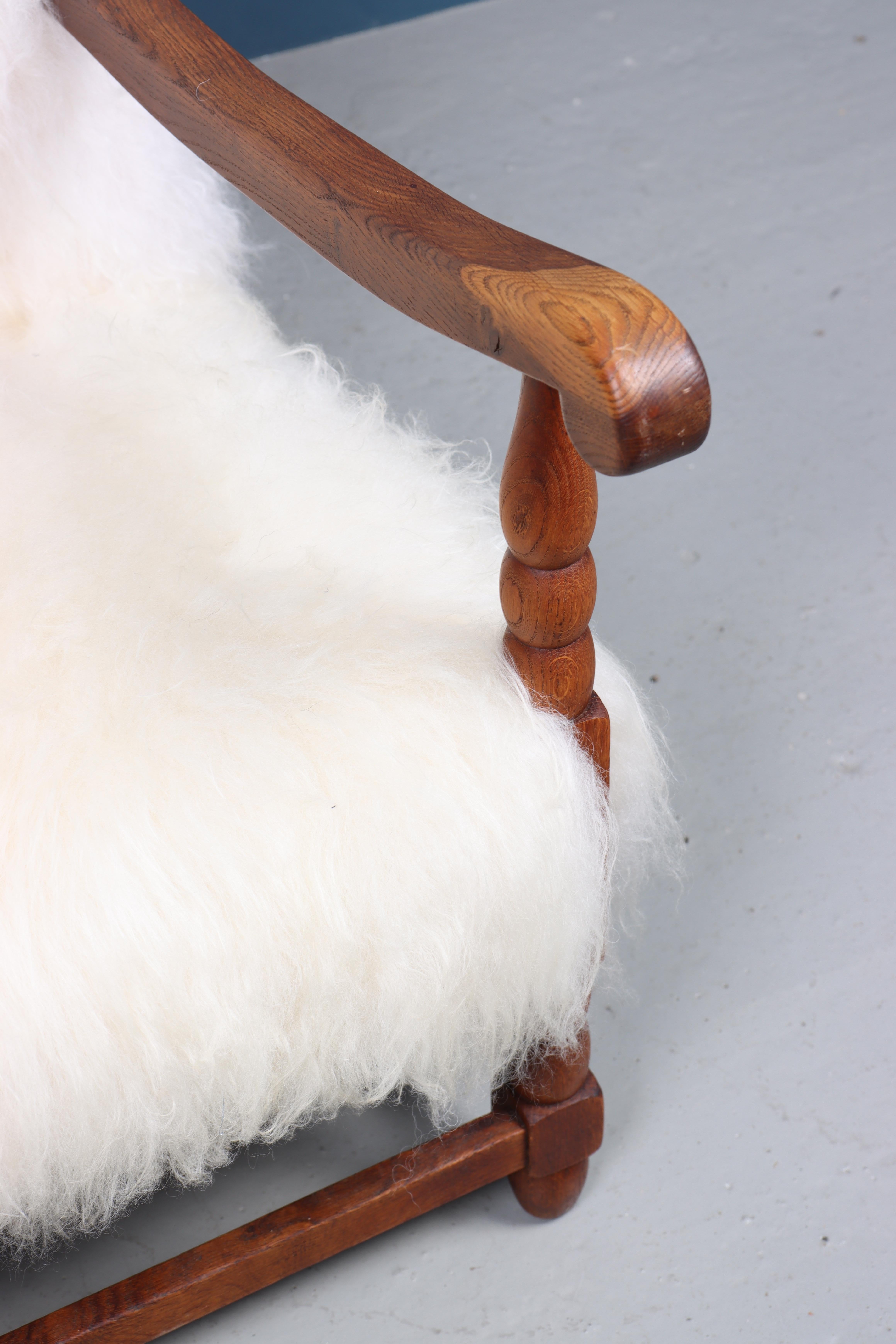 Lounge chair upholstered in solid oak and sheepskin. Designed and made in Denmark.