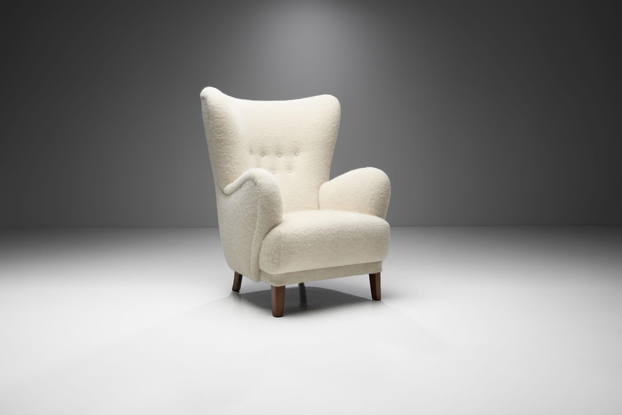 Throughout Scandinavia, there's a long history of pride in craftsmanship using natural materials like wood. This is especially true of Denmark. This beautiful wingback chair is a great representation of the quality and craftsmanship of Danish master