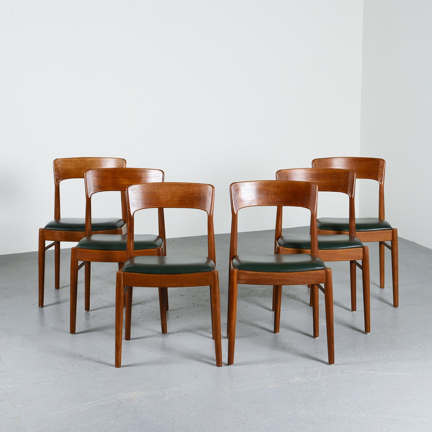 Set of six dining chairs were designed by Henning Kjærnulf in the 1960s, boasting a set of six pieces. 

The chairs are constructed with a robust teak frame that features four gently rounded legs and a curved banded backrest. Additionally, each