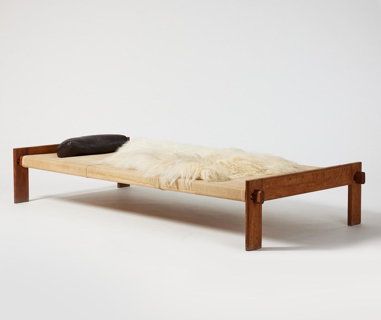 Rare Danish mid century wooden daybed in oak, canvas, sheepskin and leather by Tage Poulsen produced in Denmark, 1950s. In good original condition with patina from age and use. The canvas has some signs from water etc over the years but could be