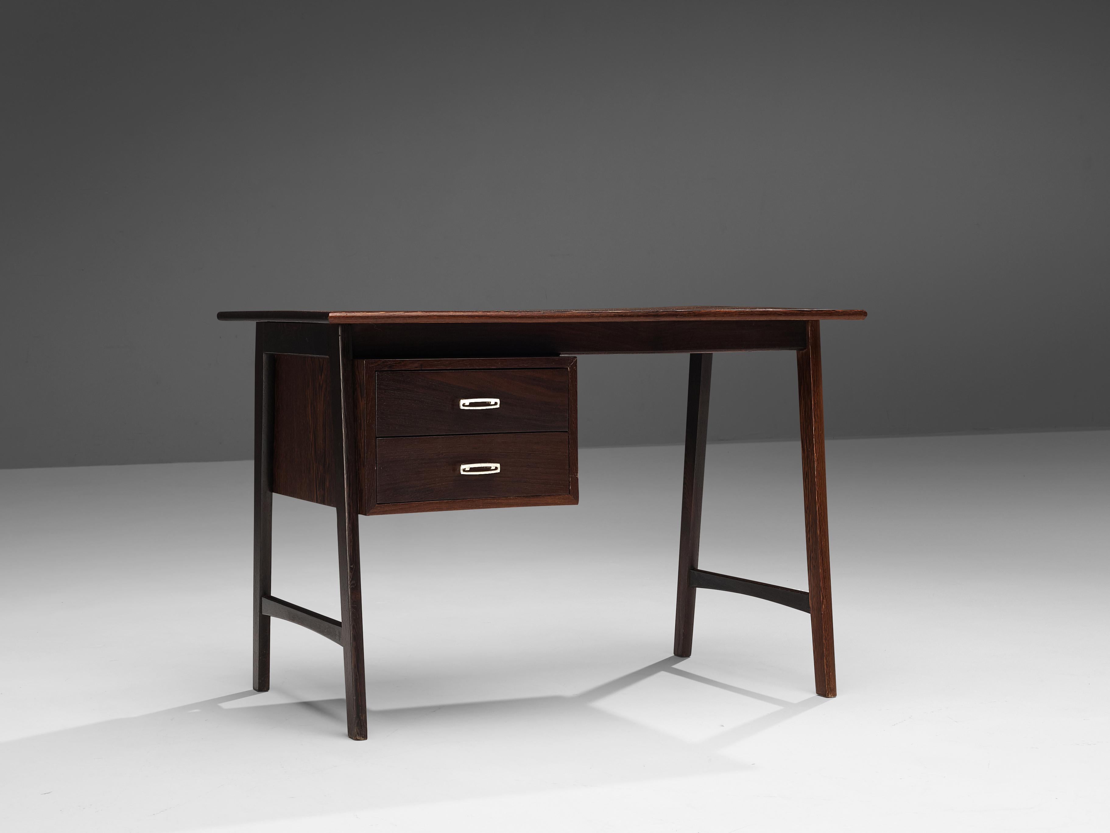 Writing desk with drawers, wengé, metal, Denmark, 1950s.

This fully restored small writing desk in expressive wengé is strong in its execution and modest in its design. The desk is executed with four legs that are connected via a horizontal beam. A