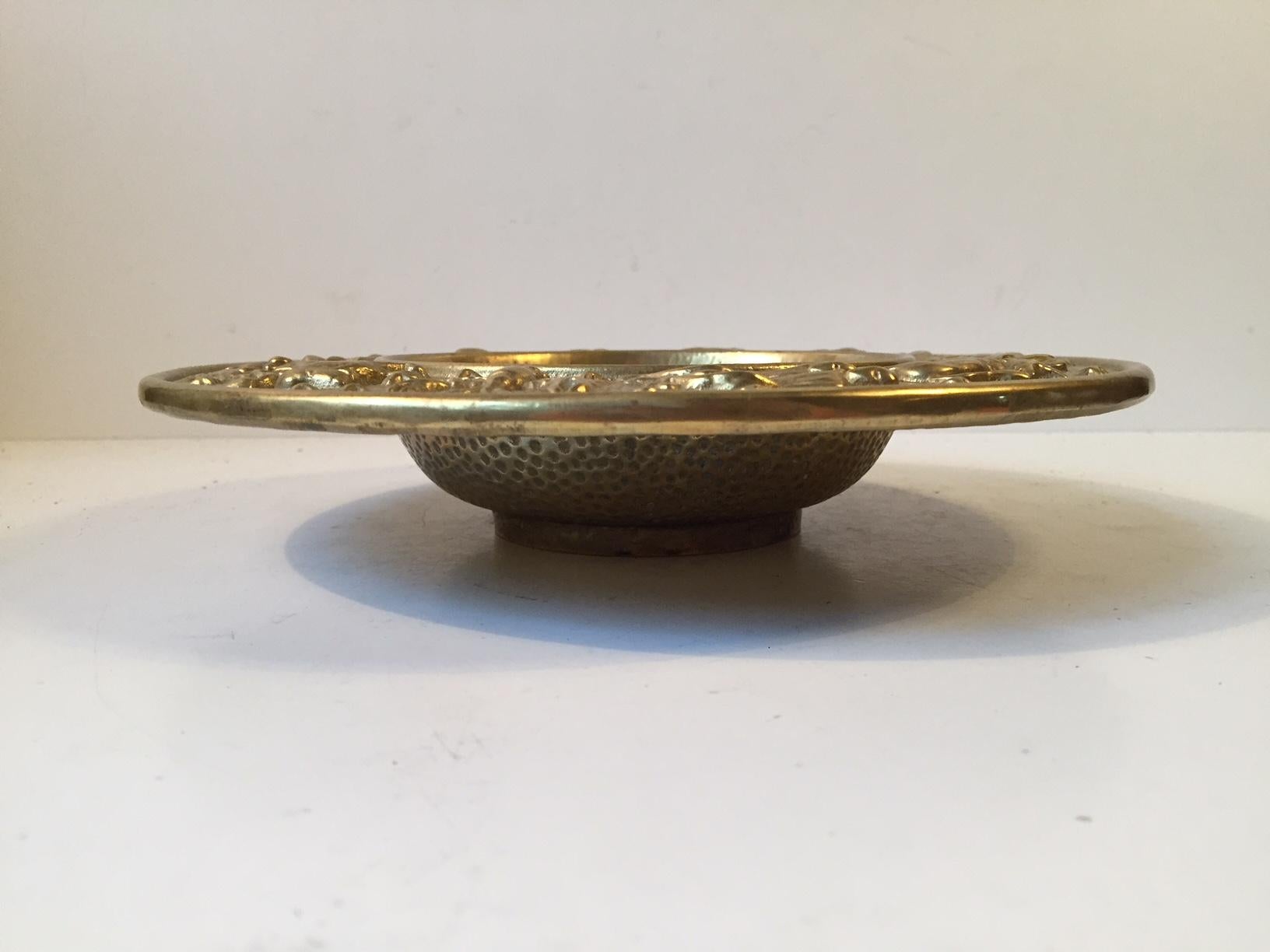 Decorative and heavy bronze bowl with Zodiac motifs/signs and a surface that mimics the surface of the moon. It was manufactured and designed by NM/Nordisk Malm in Denmark during the late 1940s. Stylistically it borderlines between Art Deco and