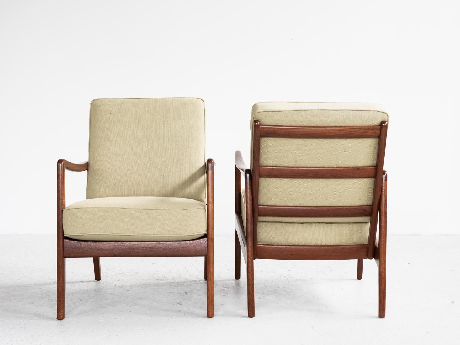 Midcentury pair of easy chairs designed by Ole Wanscher and manufactured by France & Søn in Denmark in the 1960s. It is the model with the higher backrest. The chairs have a very beautiful and light design. They have the original cushions with metal