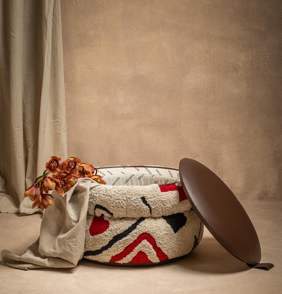 While the original leather cover is located on the upper part of the pouf, the handcrafted woven details on its body refer to Anatolian motifs in harmony with the general design language of the Khana collection. Thanks to the interior space in its