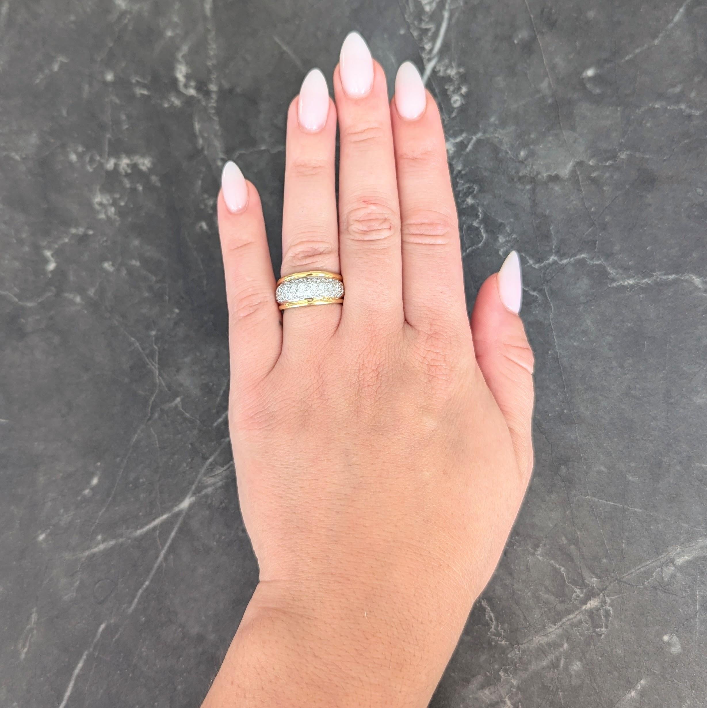 Designed as a yellow gold band ring with a slightly domed mid-section
Featuring round brilliant cut diamonds pavé set to front in white gold
Weighing approximately 1.16 carats total - G/H color with VS2 clarity
Flanked by raised edges
Stamped for 14