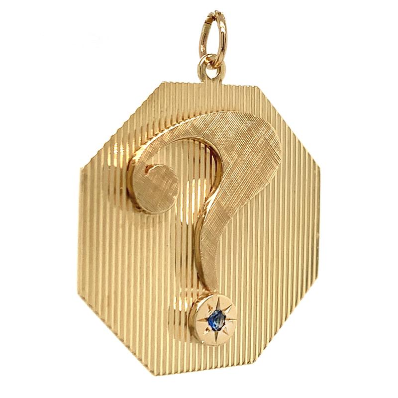 Rare and desirable question mark charm.  Made and signed by HENRY DANKNER & SONS.  Octagonal shape, Deep line engraved background with an applied matte finish figural 