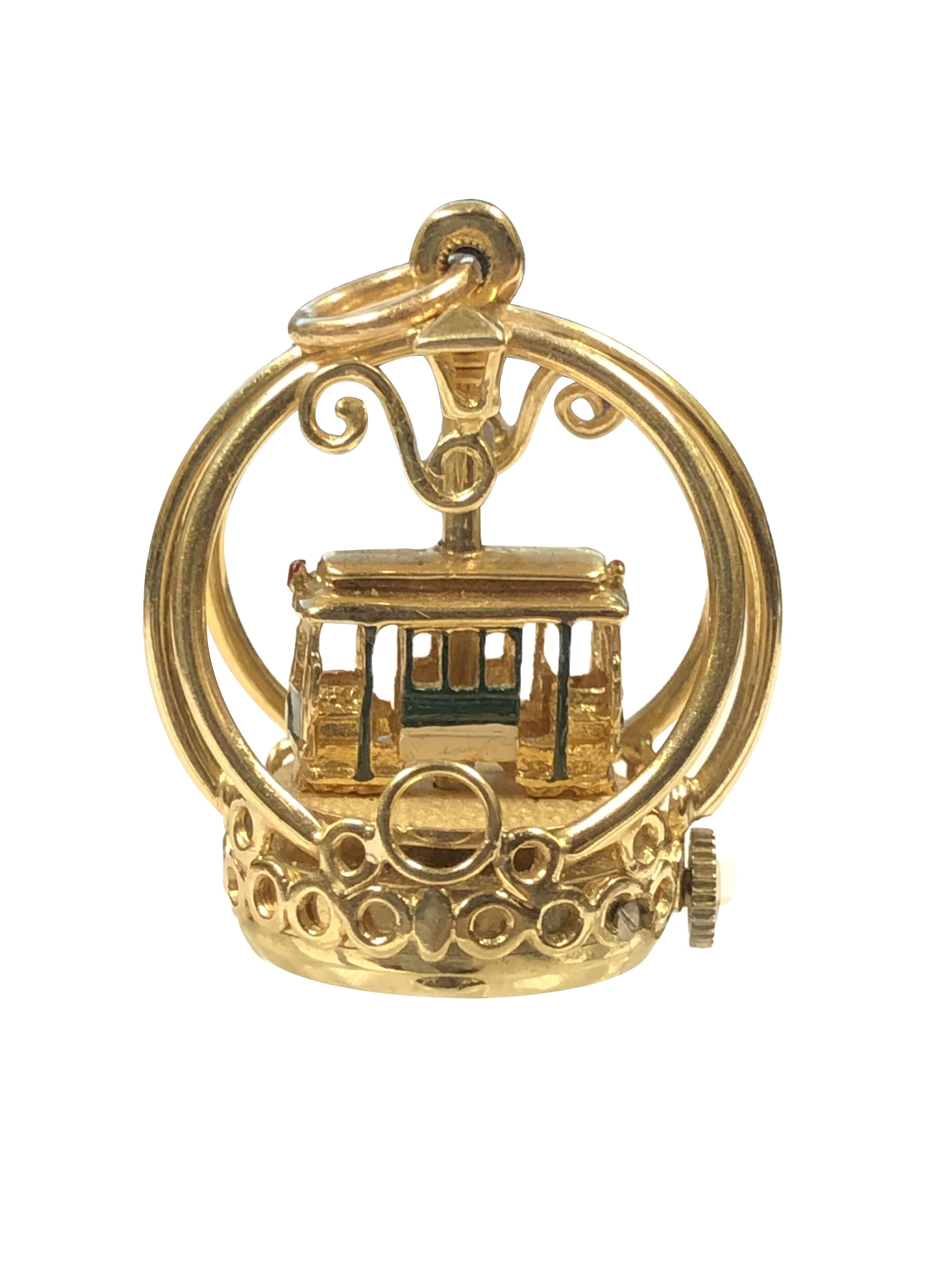 Circa 1970s Henry Dankner 14K Yellow Gold and Enamel Street Car Charm, measuring 1 3/8 inches in height 3/4 inch in diameter and weighing 16.7 Grams. Powered by a Mechanical modified Wrist Watch movement, when wound the Street Car slowly spins