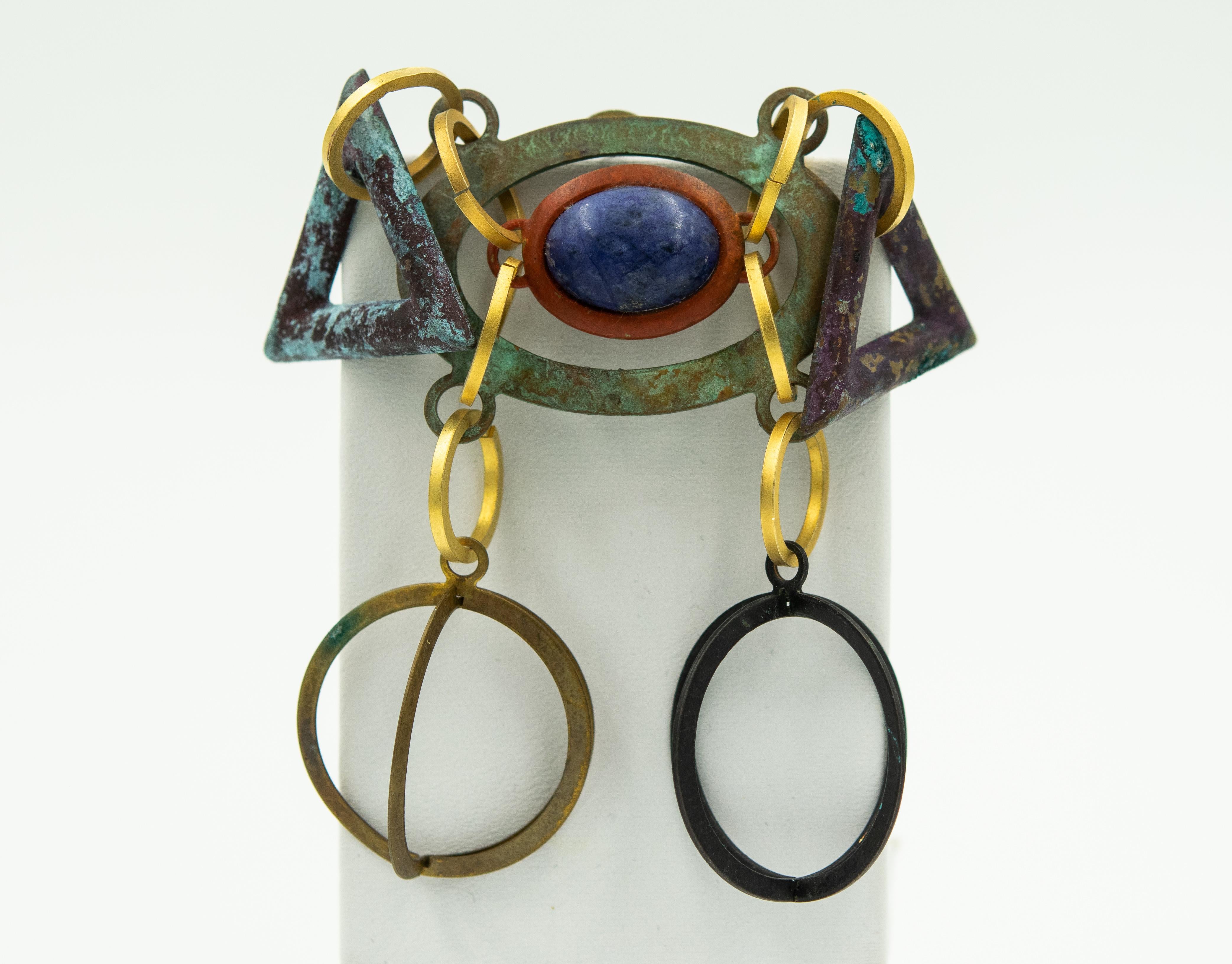 1980s Modernist industrial earrings and brooch by Dannah featuring a dangling mixed metal design with stone accents mostly onyx and chalcedony.  The pieces have tarnished over the years and have a green patina from the copper on some of the pieces.
