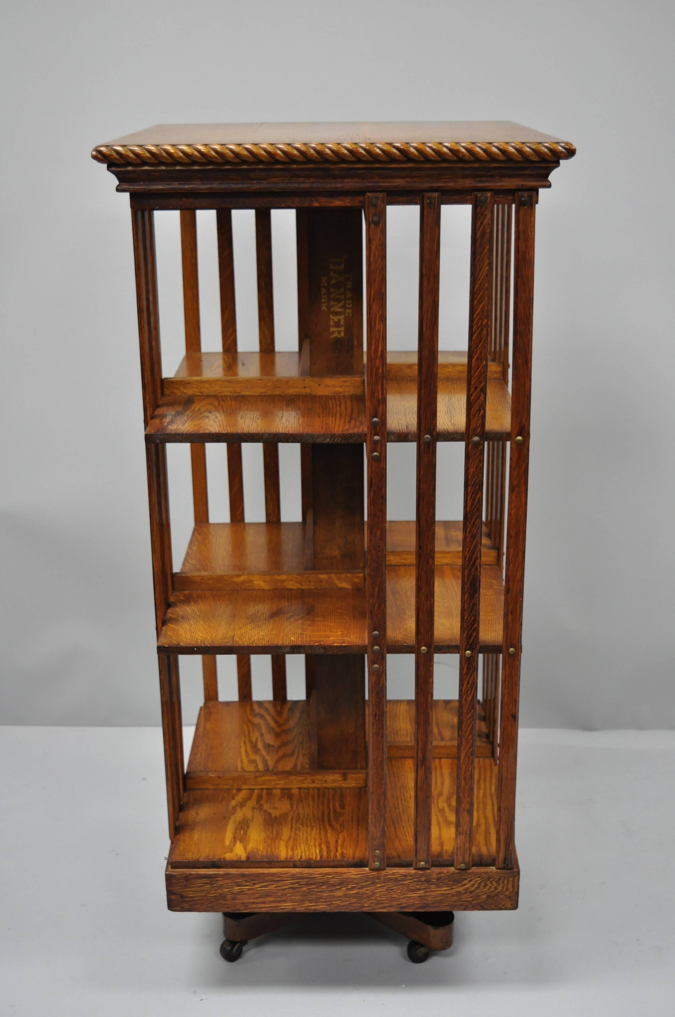 Antique Danner golden oak revolving bookcase. Item features a revolving base with rolling casters, solid wood construction, beautiful wood grain, three-tier, quality American craftsmanship, original Danner marking to center column, circa early