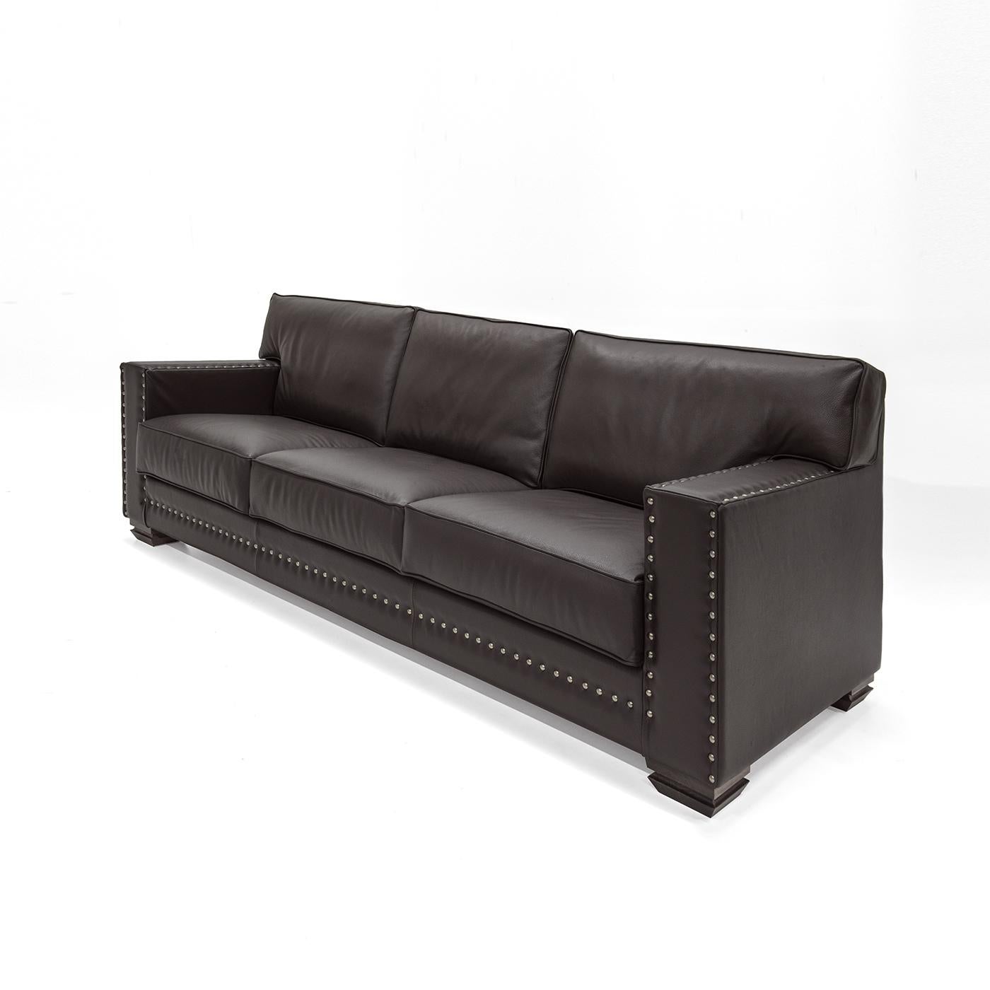 This exquisite and comfortable sofa was crafted entirely by hand and features a sturdy structure in multi-layer wood. Its soft seat features built in elastics providing suspension. The high quality upholstery is in leather and the pillows and seat