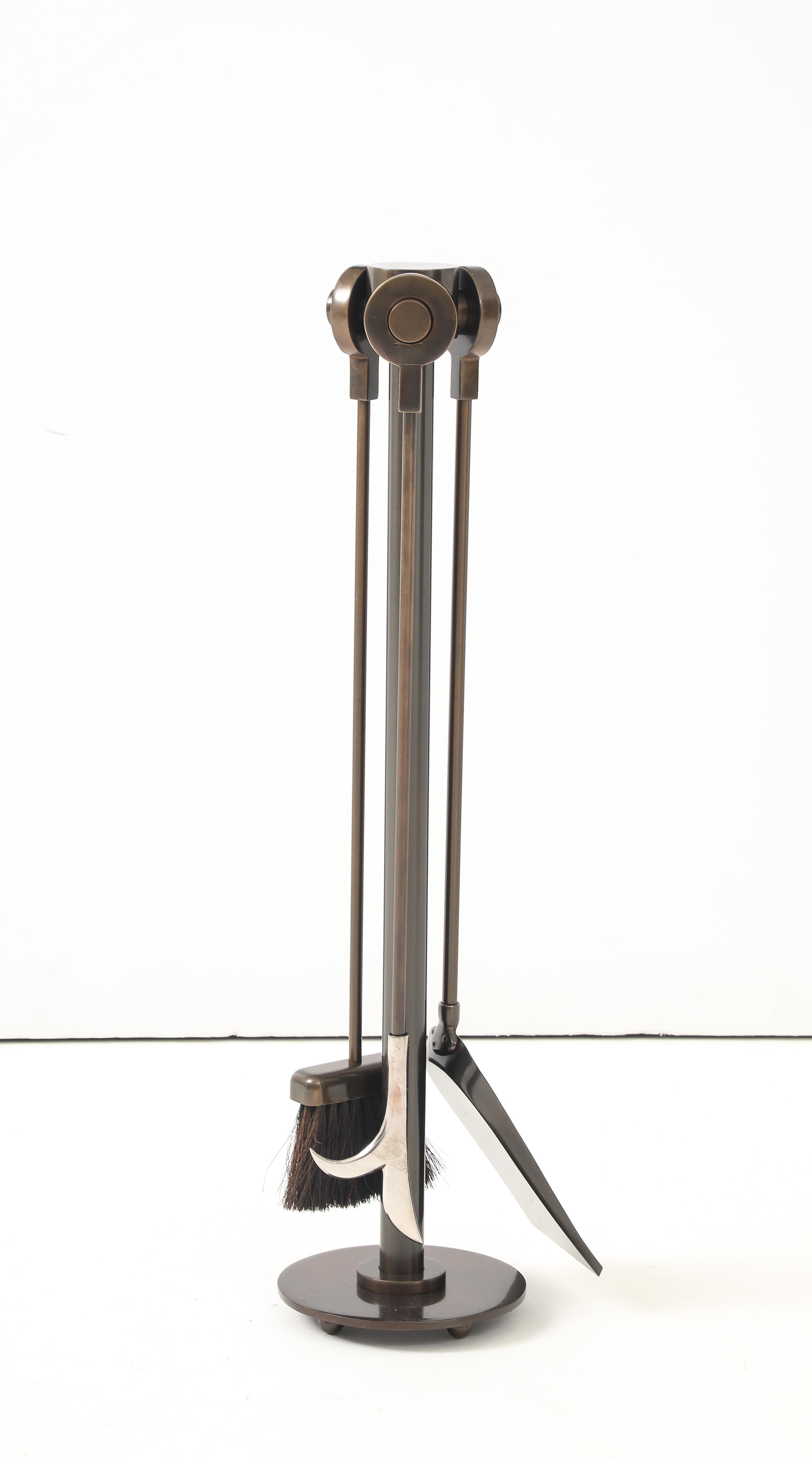 Modernist 4 piece set of Bronze fire tools including a poker, broom, shovel and stand.